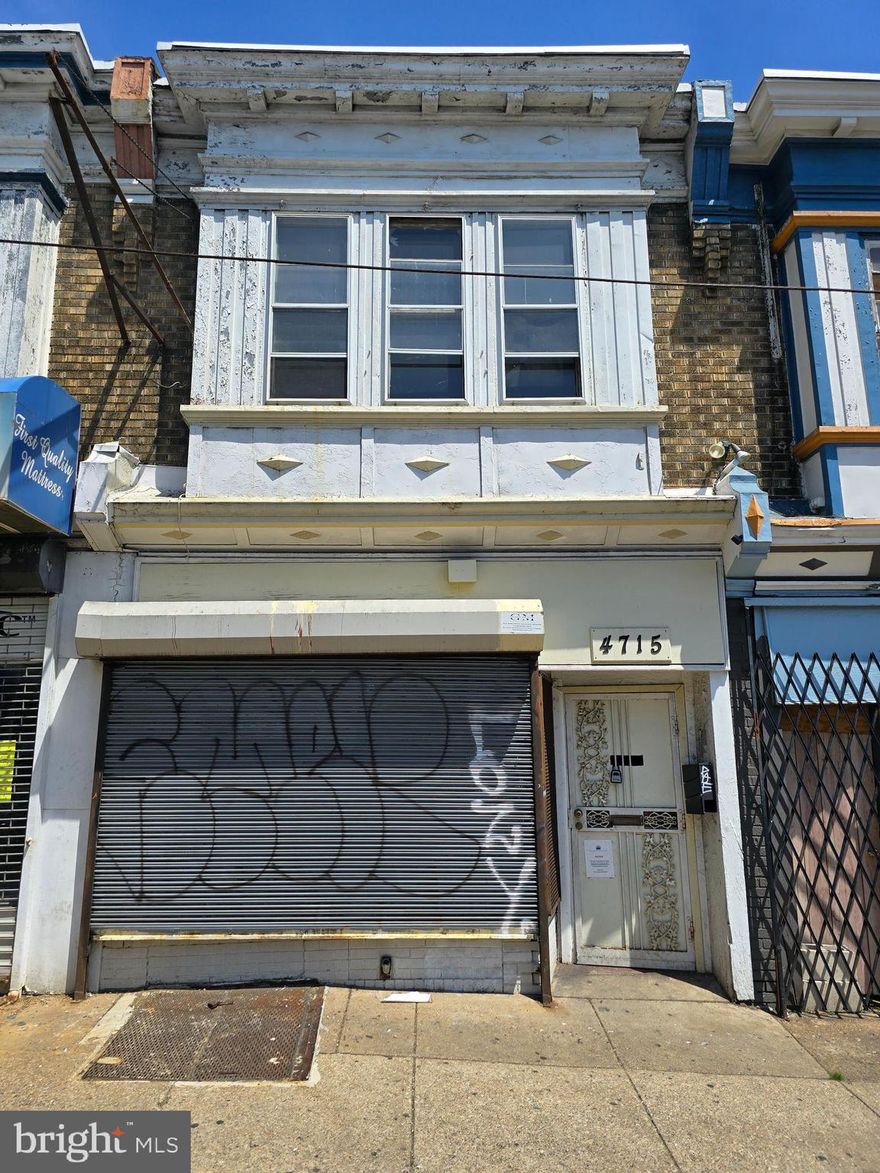 This is  a mixed use property opportunity on very busy commercial corridor. This property is located on a block that only has commercial spaces on the ground levels of each building. The inside is currently partitioned into several smaller spaces , but could easily be modified into a much larger single space. Rear of property opens into a large garage area and has functioning auto garage door.  Entry to  rear driveway from smaller rear street. 2nd floor is set up for 2 bedroom, but is large enough and should be a 3 bedroom. Property definitely needs renovation, but priced accordingly.