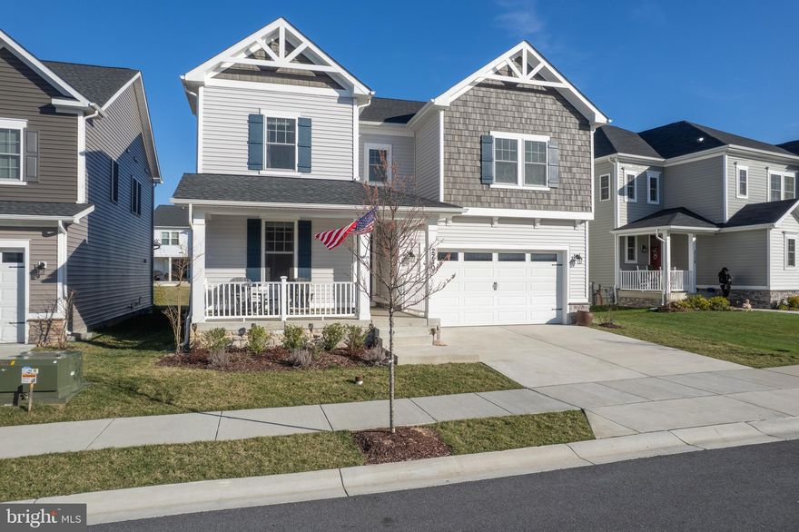 Stunning 4BR/4BA home with over $180K in upgrades, located in the highly sought-after Heritage at Two Rivers community. No age restrictions—this home is NOT in the 55+ section. Situated on a premium lot, it’s just a short walk to the community clubhouse, outdoor pool, and playground.

From the moment you arrive, the covered front porch and grand entryway set the tone for the elegance inside. The two-story foyer showcases a striking staircase with Black Diamond Finish Oak Stairs, Craftsman Newels, and Iron Balusters. The open-concept main level features a spacious gourmet kitchen with stainless steel Monogram appliances, a five-burner gas cooktop, wall oven, and a 5-in-1 microwave convection oven. A massive island with Eternal Pearl Jasmine Quartz countertops and seating for five makes this kitchen the heart of the home. Upgraded cabinetry, under-cabinet lighting, and a stylish tile backsplash add to its appeal. The adjoining great room and dining/sunroom open to a 16' x 10' covered back patio with stairs leading to the backyard. Also on the main level, there’s a bedroom and full bath, along with a mudroom/drop zone with built-in cabinets and bench for added convenience.

Upstairs, the primary suite is a true retreat with a spa-like bath featuring a soaking tub, separate shower with seat, double vanity with Seaport Quartz countertops, and a large walk-in closet. A spacious loft area provides additional living space, while two more bedrooms—one with a walk-in closet—share a beautifully designed hall bath with Blanco Matrix Quartz countertops and a double vanity. The laundry room is thoughtfully designed with built-in cabinets, a sink, and White Springs Natural Stone countertops.

The finished lower level offers an expansive rec room, perfect for entertaining with space for a bar (plumbing rough-in included), a media area, and game tables. A full bath, a large storage room, and a utility space complete the lower level.

Additional upgrades include an active radon system, tankless water heater, double-hung windows, custom paint, ceiling fan pre-wires, a furnace humidifier, and an advanced wiring system with Cat6e data and a whole-house wireless network. The home also features 8” concrete for additional insulation, a 30-year architectural shingle roof, an oversized 16’ garage door, and an 8’ exterior garage wall.

Conveniently located with easy access to DC, Baltimore, Annapolis, military bases, shopping, dining, and entertainment. This exceptional home is move-in ready—schedule your showing today!