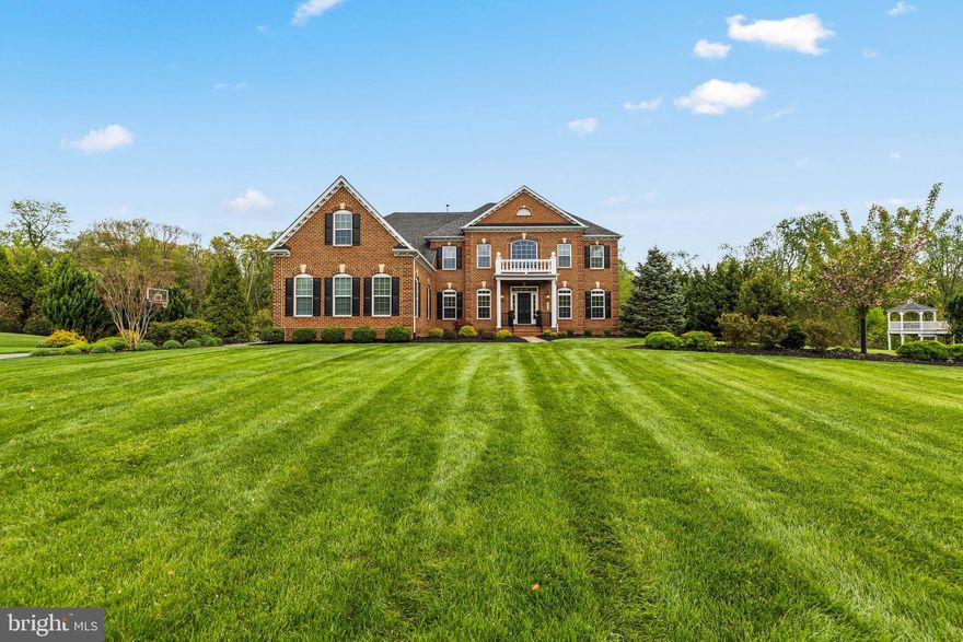 Welcome to 1004 Coachford Ct. Poised on 2.6 private acres and gently surrounded by a serene expanse of protected woods, this distinguished 2010 custom home offers nearly 7,000 sq. ft. of refined living space. Sunlight, scale, and a sense of calm define the main level, where high ceilings and elegant sightlines lead your eye toward tranquil woodland views anchored by a sophisticated gas fireplace. The kitchen, thoughtfully updated in Spring 2022, enhances the home’s everyday livability with fresh style and modern functionality. 
The upper level offers exceptional luxury with five bedrooms, each with its own en‑suite bath, including a spacious primary suite. A dedicated upper‑level HVAC system, replaced less than three years ago, ensures tailored comfort throughout the private wing. A new water heater was installed in Spring 2025, complementing the home’s strong mechanical profile. With expansive interior spaces, peaceful natural surroundings, and timeless architectural presence, this residence delivers a rare blend of privacy, scale, and everyday elegance—just moments from local conveniences and commuter routes.
