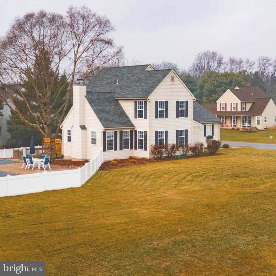 Looking for a beautiful place to call home that offers a country feel with a 3/4 acre corner lot, fenced in backyard and an inground pool? Then Misty Vale Farms is calling your name with this beautifully updated home featuring acacia hardwood floors throughout with tile bathrooms, an upgraded kitchen with stainless steel appliances, butcher block counters, wood burning fireplace, formal dining room and and a sunken family room right off the kitchen that leads to a deck and bridge to your incredible backyard with patio, raised garden beds, perennial flowers and large grasses to complete the landscaping. Warmth and openness make this a perfect home for relaxing, entertaining or game night! Sellers installed a NEW vinyl white privacy fence around the pool area, with grassy patches, a fire pit section and concrete decking with plenty of room to entertain and enjoy the outdoor serenity of your very own inground pool - with NEW HEATER! They also upgraded the second floor with all NEW HARDWOOD floors to match the main level.  The main level also features a great bonus room with glass framed french doors - perfect for home office, library, playroom - you decide!
Upstairs, the primary suite impresses with vaulted ceilings, stunning tile in the en suite bath, and an 11-ft walk in closet. Two additional upstairs bedrooms, a stylish hall bath, and convenient upstairs laundry complete the second floor. The finished basement adds even more flexibility with a media/playroom and an additional bedroom for guests. 
But the real showstopper is outside where your summer paradise awaits! Enjoy a sparkling in-ground pool with diving board. And the roof is only 8 years young! All this home needs is you and homes like this don’t come along often—don’t miss your chance to make it yours!