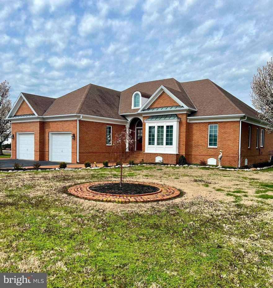 Welcome to 8 Hammock Pointe! This pristine, custom built brick home is located in the Hammock Pointe community in Crisfield, with only 18 other homes. The two story, 4-bedroom, 3.5 bathroom embodies the Chesapeake Bay waterfront living experience. On entering the home, you find the open living and dining area. The kitchen features beautiful wooden cabinets, granite countertops, stainless steel appliances and additional dining area. The lower level also holds the primary suite with beautiful water views, walk in closet and jacuzzi tub. The remaining two bedrooms located on the first floor are carpeted and share a jack and jill bathroom. Downstairs is also where you’ll find your laundry room with interior access to two car garage. The second story holds an additional primary suite which features a private office, large closet, private bath and its own balcony! An additional bonus is the 500 +sqft of unfinished area of the second story where you let your imagination run wild with design options. The exterior of home does not disappoint with landscaped yard, wrought iron fencing and outdoor living areas that include back brick porch and patio, perfect for summertime entertaining. The cherry on top is your private pier with boat lift, that has water and electric but neither currently hooked up.The HVAC was replaced in 2021, including inside unit. Don’t miss your chance to own a one-of-a-kind waterfront property with the best sunsets around!