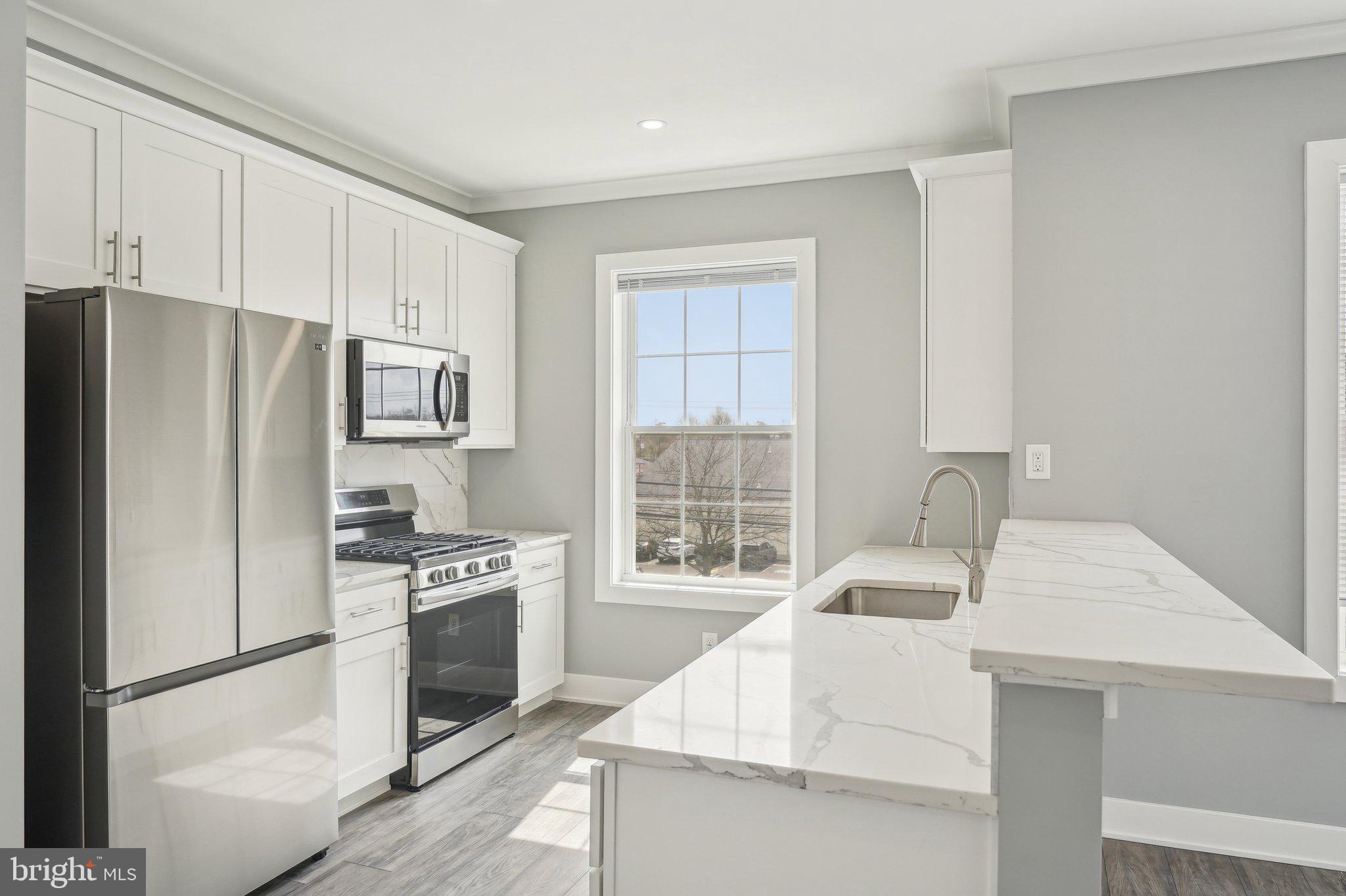 Nestled at 2421 Bristol Road in the heart of Warrington, Pennsylvania, The Warrington Place is a thoughtfully crafted residential community that blends upscale finishes, modern conveniences, and timeless style. Offering one-, two-, and three-bedroom apartment homes, the property is designed to meet the needs of today’s renters who value both form and function in a refined, suburban setting.
Inside each residence, you’ll find open-concept floorplans that maximize natural light and flow, creating a welcoming atmosphere ideal for relaxing or entertaining. The apartments feature soaring nine-foot ceilings and oversized windows, enhancing the sense of space. Gourmet kitchens are outfitted with sleek stainless steel appliances, white shaker-style all-wood cabinetry, quartz countertops, subway tile backsplashes, and oversized islands or breakfast bars in select layouts—perfect for morning coffee or evening meals. Luxury vinyl plank flooring throughout the main living areas adds a stylish, durable touch, while plush carpeting in the bedrooms provides cozy comfort.
Each apartment also includes smart Samsung appliances such as in-unit washers and dryers, allowing residents to handle laundry at their convenience. Spacious bathrooms feature modern vanities, chrome fixtures, and tiled showers or deep soaking tubs. Large walk-in closets provide generous storage, and private balconies or patios in most units offer a quiet space to enjoy the outdoors. Select homes offer premium views or corner locations for even more natural light and privacy.
Beyond the units themselves, The Warrington Place provides a well-maintained environment with controlled access entry, ample private parking, and professional on-site management. The community is located at the intersection of Bristol Road and Route 611, giving residents unbeatable access to major retail destinations and everyday essentials. Whole Foods, Wegmans, Giant, Target, Walmart, Costco, Amazon Fresh, and ShopRite are all within a short drive, making errands quick and easy. Public transportation is also convenient, with a nearby SEPTA bus stop offering a simple commute for those who prefer not to drive.
Warrington itself offers a charming, residential atmosphere with the conveniences of modern suburbia. Residents will enjoy close proximity to a variety of restaurants, local parks, fitness centers, and entertainment venues such as the Regal Cinema. The area is known for its peaceful streets, well-maintained green spaces, and an easy-going pace that makes coming home feel like a true retreat.
The Warrington Place is more than just a place to live—it’s where style meets substance, and convenience meets comfort. Whether you're a busy professional, a downsizer, or someone seeking elevated suburban living, this community delivers a lifestyle that feels both luxurious and effortless.
** Photos are of model units ** Pricing and availability subject to change on a daily basis **