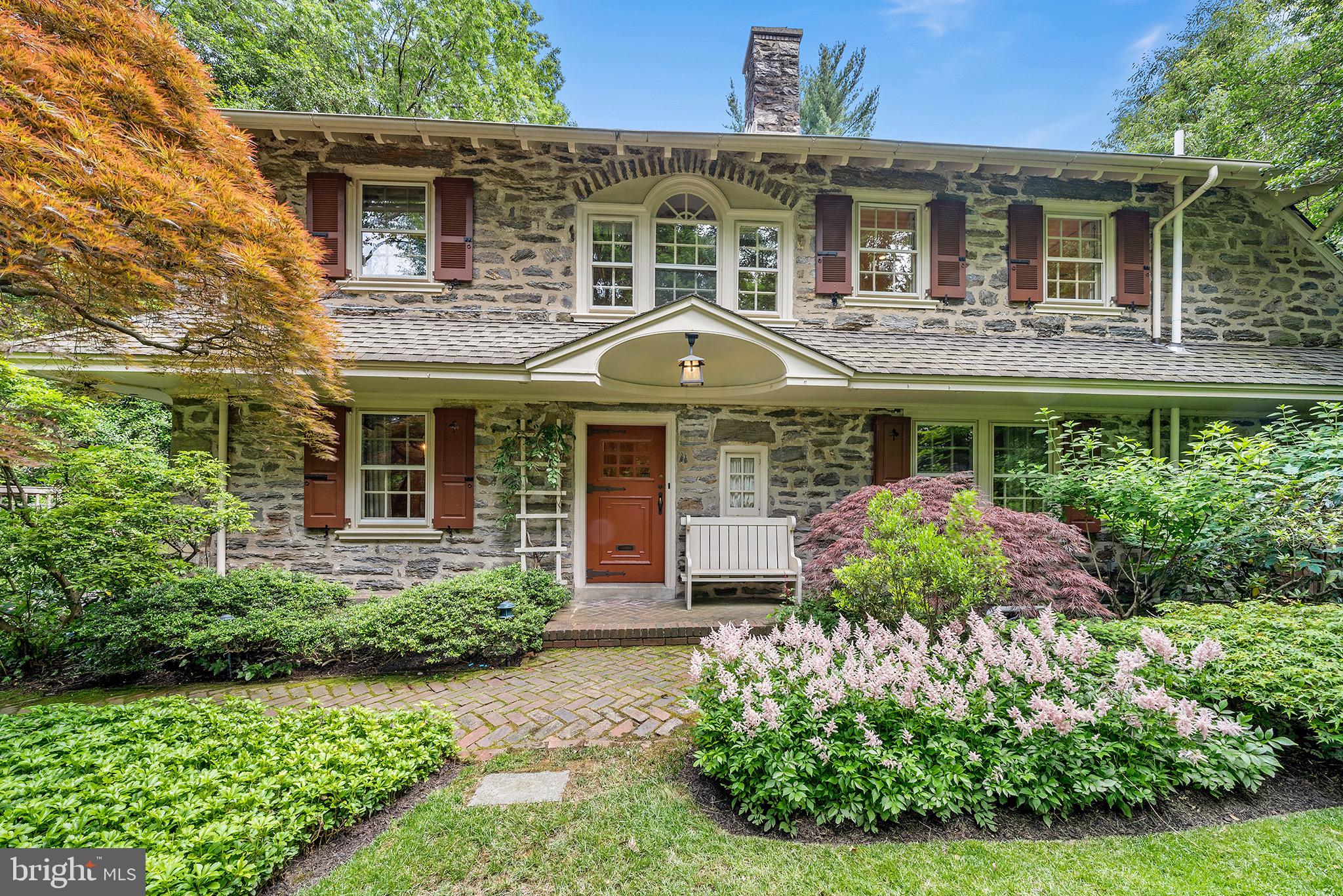 Welcome home to 1014 West Hortter Street, a classic West Mount Airy colonial stone residence set atop lush manicured grounds located steps away from the Wissahickon Trails. As you approach the property, you will be greeted by gorgeous Japanese maple trees that adorn the front lawn. Breeze past the classic Wissahickon schist facade and enter into the home's central hall. The hallway connects the dining room, kitchen, and living room - each generously sized. The kitchen features Thermador, SubZero, Bosch and Gaggenau appliances, a central island, and separate breakfast nook that leads directly to a stone patio - perfect for entertaining. The expansive living room is situated next to the kitchen. Offering wonderful views of the grounds, the living room also features a fireplace and separate den with window seating. Architect Susan Maxman helmed a renovation that brought real and faux French doors into the living room, to visually connect the house with the gardens. A stately dining room as well as a convenient powder room complete the first level. Take the windowed stairwell up to the second floor landing, being sure to inspect the views on your way up. Four bedrooms and three bathrooms are accessible from the second floor landing. A character archway and a handful of curved window walls add sophistication while things like bespoke wallpaper and hidden closet drawers pack the charm. The primary suite is accessed via a private door that leads into its sitting area, which is flanked by five distinct closets, the bedroom and an en suite bathroom. The sunny primary bedroom features a wall of windows and is situated next to the ensuite bathroom which offers dual vanities as well as a glass enclosed shower and internal linen closet. The primary suite comes complete with a built-in desk overlooking the grounds. An additional door off of the hallway leads to a third floor flex space, which could be utilized as an office, fitness or play area. This home additionally features an expansive basement, large cedar closet and stand-alone garage. Before leaving the property, be sure to explore its best feature: An iron gate at the back of the house leads to what could only be called an "oasis". From the azaleas and hydrangeas to the berry garden and specimen trees, the rear and side yards are something out of a fairytale. A frog pond with waterlilies and a hidden swimming pool bring tangible bliss to this already exceptional home. 1014 W Hortter is in close proximity to popular Mount Airy Village, the Wissahickon Trails (access to the White Trail is at the end of Hortter!), and Chestnut Hill. Commuting to Center City by car or train is a breeze! We hope you will visit; 1014 Hortter is a true delight to the senses. |||| Floor plans are available. Disclaimer: Square footage and room measurements should be independently verified by buyers and their salespersons. The City of Philadelphia has completed a real estate tax reassessment, effective January 1, 2023. If you have any questions or concerns about the impact of this reassessment on future real estate taxes, please contact the City of Philadelphia. Compass RE is not involved in the City of Philadelphia’s tax reassessment and does not have any input or control in the results.