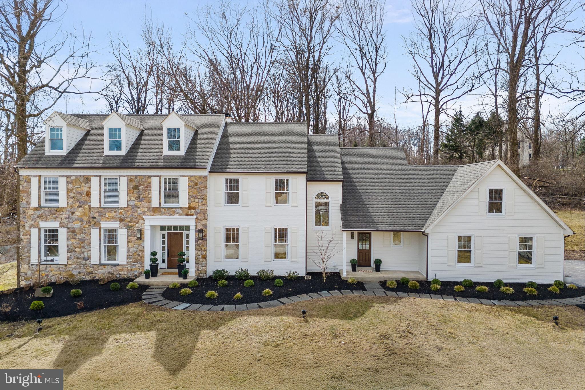 This Malvern Colonial is where modern updates and amenities meet classic charm and character. You will get all the benefits of new construction without any of the waiting. Recent remodels and updates abound as you take in all this stunning home has to offer. As you drive up the private driveway, you will notice the exterior has been fully updated by removing all stucco and replacing it with custom-color James Hardie siding, as well as painted brick veneer, new gutters, downspouts, and re-flashed windows. The doors on the three-car side entrance garage have all been replaced, and the back yard has been recently landscaped with new patios. The rear yard extends above the hill for additional options and benefits. Walk inside and you will be warmly greeted by the huge foyer featuring a wall of windows, with a formal living room to your left and formal dining room to your right. There is a professional office, updated half bathroom, cozy yet spacious family room with fireplace, and a fully renovated kitchen with custom cabinets and breakfast room. The mudroom has also been fully renovated with new built-ins and flooring. New flooring throughout with both new hardwood floors, as well as re-finished hardwood to match, new carpeting in bedrooms, office, and staircases, and new luxury vinyl plank floors in the finished basement. The fully finished basement features an additional living area, possible fifth bedroom, another fully renovated full bathroom, and unfinished storage area. There is a second back staircase in addition to the main staircase to bring you to the second floor where all bedrooms are wonderfully sized. Two bedrooms share a renovated hall bathroom, while the back bedroom features its own private updated bathroom. The primary suite offers a separate sitting room, two custom walk-in closets, and a masterfully renovated primary bathroom with oversized shower, new flooring, double sink and new vanity, light fixtures, and more. You have to see these gorgeous updates and touches for yourself to truly understand everything this dream house has to offer. Don't miss it before it's gone!