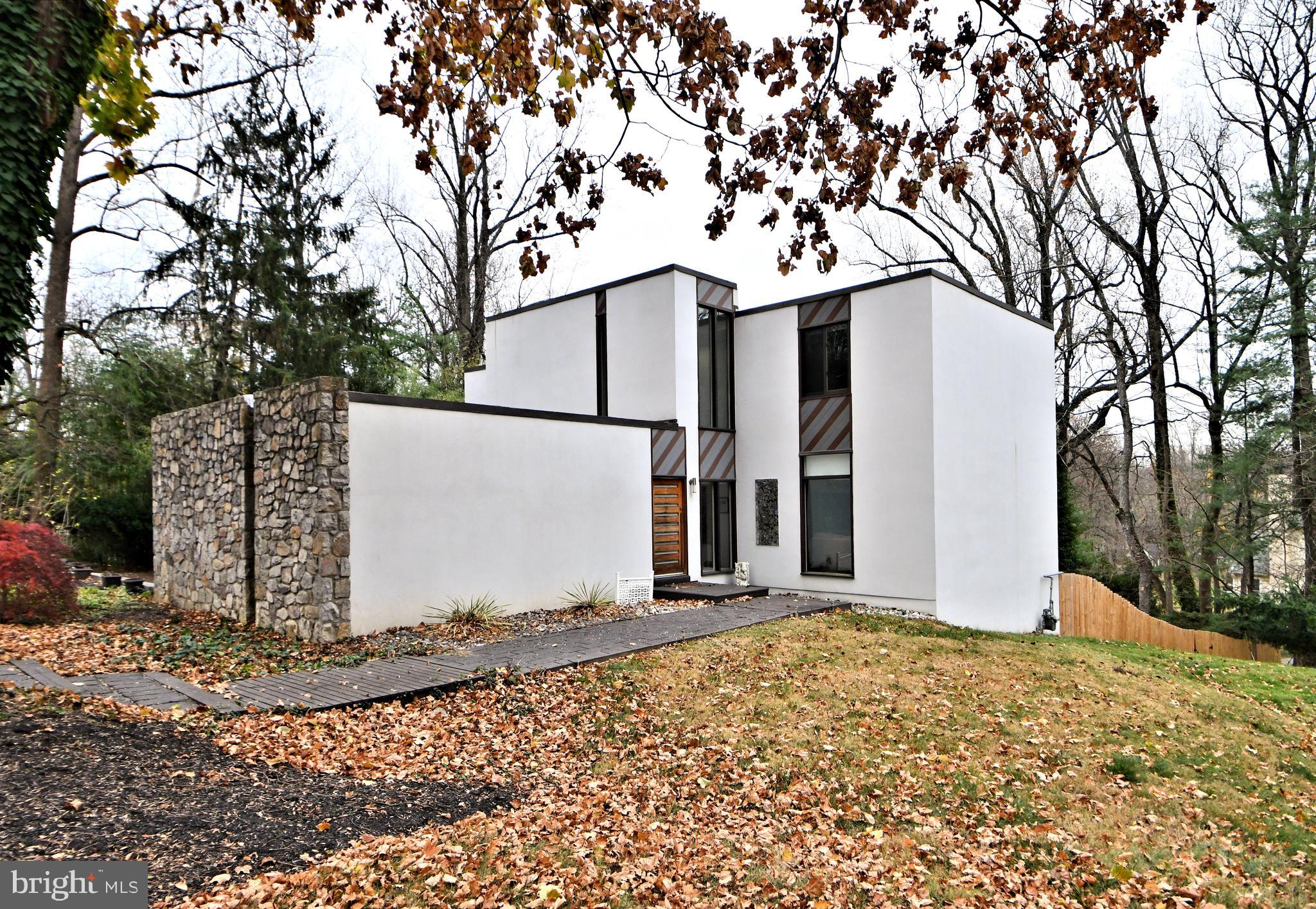 You won't want to miss this custom-built , contemporary home. Commissioned by the former owner of Rock Rose Estate, and designed by Edward E Robinson, no detail was spared in the home's design, construction and setting. Built using Stone and Stucco on just shy of an acre on a large corner lot of a cul-de-sac street, the home is surrounded by beautiful old trees and lush plantings offering privacy, lushness and convenience. Be sure to take the short drive to the center of Wayne, the "hub" of the Mainline, where you'll be drawn to its walkability to shops, restaurants, and the train line into Philadelphia. King of Prussia Mall and town center are not too much further of a drive. Approach the home from the street and take in the large circular drive and custom front door. Inside you are greeted by a stunning two-story foyer with wonderful natural light and a porcelain tile floor. The center hall is situated conveniently between the large living/family room, the formal dining room, and the kitchen. All of these rooms have huge windows and sliding doors providing panoramic views and access to your backyard oasis, while bathing the home in natural light from dawn until dusk. Just to your left you will notice a striking custom-built staircase that the current owners had imported from Italy. It suits the home like a work of art and glistens both day and evening with its fabulous "low-lighting". Imagine the entertaining you will do in the wonderful flow and setting of this home. You will see yourself spending many hours in the fabulous upgraded family kitchen. From the huge deep cabinets and drawers to the high-end stainless appliances, and sleek quartz counters you will be inspired to whip up fabulous meals, and/or sip wine or coffee while sitting by a cozy fire and soaking in the sun's warm rays. A convenient pantry sits just off the kitchen with another huge refrigerator, sink, and counter, and adjacent garage access. Both the dining and living rooms are large enough to hold today's larger scale dining and living room furniture. All the bathrooms are luxuriously updated including a convenient powder room on the main level. The well-designed primary suite offers spa-like luxury and serene privacy. You will find a convenient laundry, large window, his& hers custom-clad walk-in closet, and a gas fireplace. The ensuite bath is pure bliss with a bright skylight, huge rainfall shower, whirlpool tub for two, and heated towel rack. You will find it hard to leave this space! There are three remaining spacious bedrooms that feature hardwood floors, large windows, closets, and even a built-in bookcase in the current office. The upgraded hall bath will a magnet for family and guests alike with its huge spa-like shower, double vanity, and wonderful skylight. Heading back down to the walkout lower level of the home you'll find a full kitchen, a full bathroom with large washer/dryer combo, a family room, and two additional rooms that can serve as bedrooms, or flex rooms. This living area provides additional access to your fabulous backyard oasis. Imagine family gatherings and peaceful days by the inground pool surrounded by lovely landscaping and the striking tiered decking. as you can see, every inch of this fabulous home has been well thought out and constructed. Space, luxury, and convenience to suit a growing family or entertaining enthusiasts. Families will appreciate the award winning Radnor schools. Don't miss your chance to own this wonderful home in this sought-after location.
