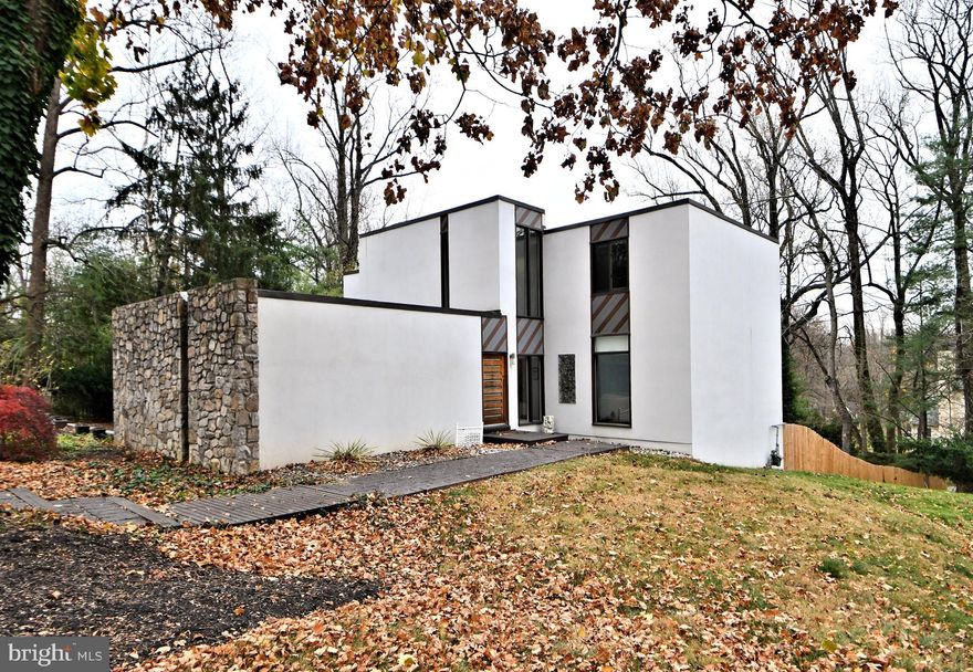 You won't want to miss this custom-built , contemporary home. Commissioned by the former owner of Rock Rose Estate, and designed by Edward E Robinson,  no detail was spared in the home's design, construction and setting.  Built using Stone and Stucco on just shy of an acre on a large corner lot of a cul-de-sac street,  the home is  surrounded by beautiful old trees and lush plantings  offering privacy,  lushness and convenience. Be sure to take the short drive to the center of Wayne, the "hub" of the Mainline, where you'll  be drawn to its walkability to shops, restaurants, and the train line into Philadelphia.  King of Prussia Mall and town center are not too much further of a drive.  Approach the home from the street and take in the large circular drive and custom front door.  Inside you are  greeted by a stunning two-story foyer with wonderful natural light and  a  porcelain tile floor. The center hall is situated conveniently between the large living/family room, the formal dining room, and the kitchen.  All of these rooms have huge windows  and sliding doors providing  panoramic views and  access to your backyard oasis,  while bathing the home in natural light from dawn until dusk.  Just to your left you will notice a striking custom-built staircase that the current owners had imported from Italy. It suits the home like a work of art and glistens both day and evening with its fabulous "low-lighting".  Imagine the entertaining you will do in the wonderful flow and setting of this home. You will  see yourself spending  many hours in the fabulous upgraded  family kitchen.  From the huge deep cabinets and drawers to the high-end stainless appliances, and sleek quartz counters you will be inspired to whip up fabulous meals, and/or sip wine or coffee while sitting by a cozy fire and soaking in the sun's warm rays.  A convenient pantry sits just off the kitchen with another huge refrigerator, sink, and counter, and adjacent  garage access.  Both the dining and living rooms are large enough to hold today's larger scale dining and living room furniture.  All the bathrooms are luxuriously updated including a convenient  powder room on the main level. The  well-designed primary  suite  offers spa-like luxury and serene privacy.  You will find a convenient laundry, large window,  his& hers custom-clad walk-in closet, and a gas fireplace. The ensuite bath is pure bliss with a bright skylight,  huge rainfall shower,  whirlpool tub for two, and heated towel rack.  You will find it hard to leave this space! There are three  remaining spacious bedrooms that feature hardwood floors, large windows, closets, and even a  built-in bookcase in the  current office. The upgraded hall bath will a magnet for family and guests alike with its huge spa-like shower, double vanity, and wonderful skylight. Heading back down to the walkout lower level of the home you'll find a full kitchen, a full bathroom with large washer/dryer combo, a family room, and two additional rooms that can serve as bedrooms, or flex rooms. This living area provides additional access to your fabulous backyard oasis. Imagine family gatherings and peaceful days by the inground pool surrounded by lovely landscaping and the striking tiered decking. as you can see,   every inch of this fabulous home has been well thought out and constructed.  Space, luxury, and convenience to  suit a growing family or entertaining enthusiasts.  Families will appreciate the award winning Radnor schools.  Don't miss your chance to own this wonderful home in this sought-after location.