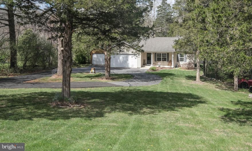 Welcome home to this inviting 3-bedroom, 2-bath retreat—perfect for families or those looking to enjoy a peaceful, easy lifestyle. Country kitchen with all stainless steel appliances. The backyard gently slopes into the tranquil Opequon Creek, (not in the flood plain), offering a perfect spot to fish, wade, or relax by the water with loved ones. A fenced-in backyard keeps pets and little ones safe, while the two-car garage and blacktop driveway add everyday convenience. Complete with hardwood floors, a large deck, and a fire pit. Tucked in a quiet setting yet ideally located for commuters—just 70 miles from Washington, D.C., and close to Virginia, Maryland, and Pennsylvania. A wonderful blend of comfort, nature, and accessibility—ready for your next chapter.