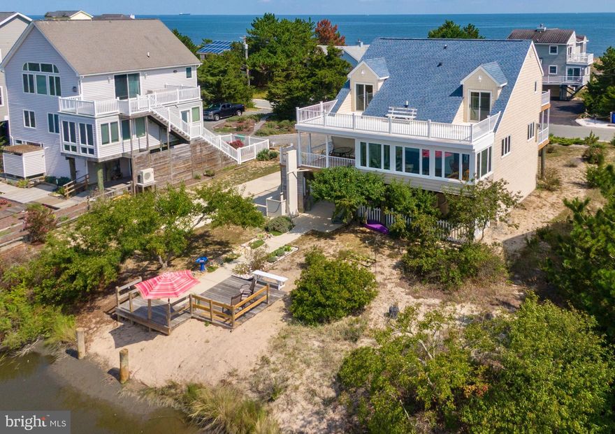 Rare find on the highly desirable south end of Broadkill Beach.  Nature lovers find themselves immediately at home -- savor a beautiful sunrise with your morning coffee, and end your day with a magical Broadkill sunset over Deep Hole Creek and the Prime Hook National Wildlife Refuge.  Multiple decks on all levels provide access to every possible view -- a front deck with views of the Delaware Bay,  and 2 rear decks overlooking the Refuge.  The rear of the home features a recently enclosed 4 season room with minisplit which connects with a great deck for grilling and a lift to help with groceries as well as heavy furniture.  3 bedrooms, 3 full baths, and upgraded, zoned HVAC for maximum energy efficiency.  Gas stove in living room gives comfort on cooler days, and a main level generator to keep essentials running.  Kayakers, crabbers and fishing enthusiasts will love creek access, as well as beach access points to enjoy the sandy bay beach.  Huge garage can fit up to 4 cars and plenty of room for beach toys.  Should you have an RV, a power post is on site.   Use full time, part time, or as a rental with great income potential.  You decide -- just don't wait!