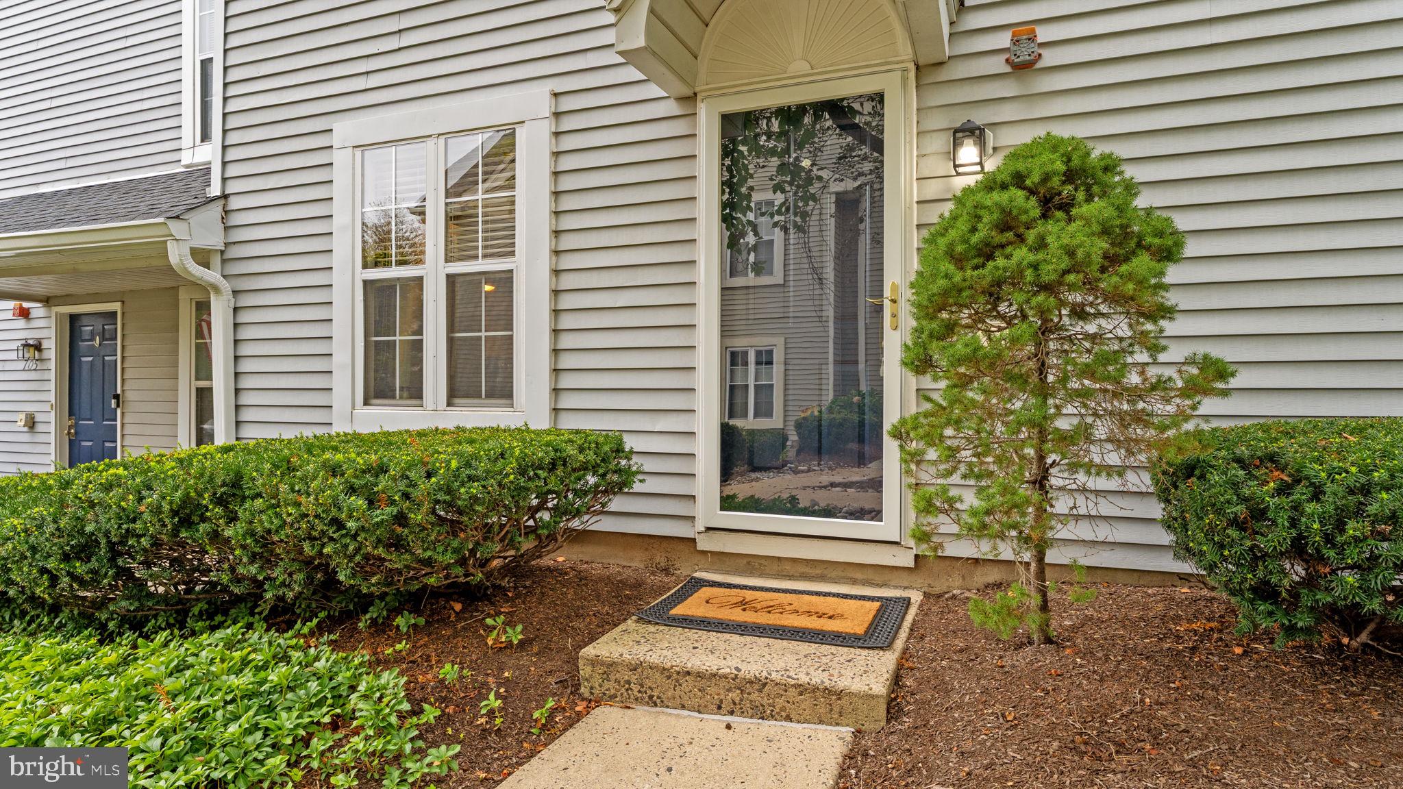 Welcome to this beautifully refurbished first-floor condo in the highly desirable Society Place at Newtown Grant! This move-in ready home features 2 spacious bedrooms, a bright living room and dining area, and a sliding door leading to your private patio with outdoor storage closet. The completely updated interior showcases all-NEW hickory Coretec flooring and FRESH designer neutral paint throughout, and gas heating ensures efficiency and comfort year-round! A bright cherry kitchen with pass-through to dining area boasts brand new premium GE stainless steel appliances, granite counters, tiled backsplash and gas cooking! The primary bedroom offers a generous walk-in closet, and the second bedroom is also suitable for WFH office space! A private patio overlooks lawn green space and offers an outdoor storage closet. Set in a prime location with plenty of parking, this home provides access to the incredible amenities of Newtown Grant—including a community clubhouse with planned activities, swimming pools, tot lots, basketball, tennis and pickleball courts, plus bike and pedestrian walking paths woven throughout the neighborhood. All this, just minutes from Tyler State Park, the shops and dining of the Village at Newtown, and historic downtown Newtown Boro! It is all ready for you! This completely turnkey condo offers low maintenance living in a vibrant community! Don’t miss the opportunity to call it yours!