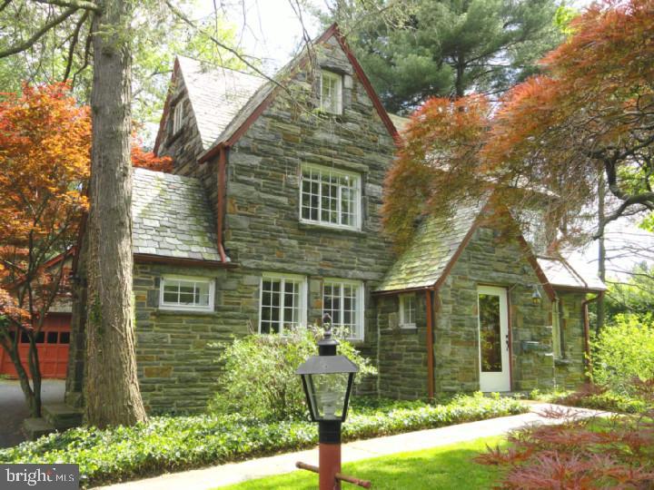 Nestled into a deep lot, this all stone English Tudor has 3-4 bedrooms, 2   baths, lovely hardwood floors, new ceramic tiled hall bath, freshly painted, knob and tube wiring has been remediated, central air, detached garage, and a newer eat-in kitchen with granite countertops and new appliances. Excellent schools, great town and minutes to everywhere. Location is everything!