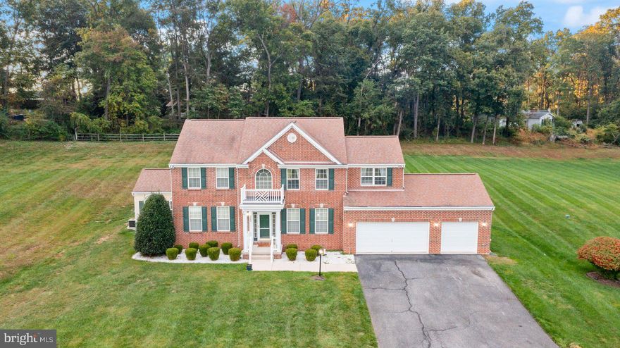 Built in 2004, this elegant 3-level residence combines timeless craftsmanship with modern sophistication, offering over 2.7 acres of privacy and serene tree-lined views. A rare opportunity awaits to own this thoughtfully designed 4-bedroom (potential 5th bedroom), 3.5-bath estate.

The main level is an entertainer’s dream, featuring gleaming wood floors, a formal dining room, a sun-filled living room, a private office, and a welcoming family room with fireplace. The gourmet country kitchen boasts a center island, upgraded countertops, and table space, with seamless flow into the sunroom and breakfast area that open to the patio. A main-level laundry adds convenience, while oversized windows throughout capture natural light and frame the picturesque setting.

The luxurious primary suite offers a spa-inspired bath, while additional spacious bedrooms provide comfort and flexibility for family or guests. Modern amenities include upgraded appliances, French and sliding glass doors, double-pane windows, and an integrated intercom system.