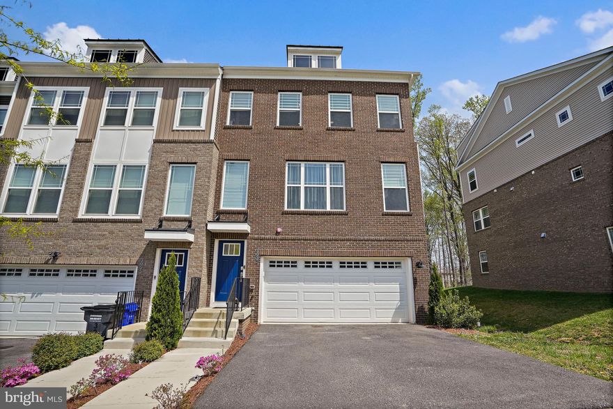 Luxury 4-level end-unit townhome with a 2-car garage located in Bryans Village, offering modern finishes and a functional layout with plenty of flexible living space. The main level features wide plank flooring and an open layout that connects the living, dining, and kitchen areas. The kitchen includes granite countertops, painted linen cabinetry, a designer backsplash, and brushed nickel fixtures, creating a clean and inviting space. Upstairs, the spacious bedrooms provide comfort and privacy. The primary suite features granite countertops, upgraded tile, and coordinated finishes that continue into the additional bathrooms. Plush carpeting adds warmth to the upper level. The loft level offers extra living space with access to a private deck, perfect for a home office, lounge, or guest area. The lower level includes additional flexible space and a powder room, ideal for everyday use or guests. The exterior features a mix of brick and siding, a front-load garage, and attractive architectural details. Conveniently located near I-495, I-295, National Harbor, Joint Base Anacostia-Bolling, Tanger Outlets National Harbor, as well as shopping, dining, and entertainment.