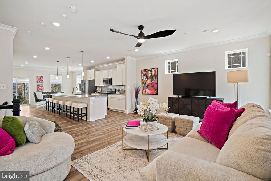 Luxury 4-level end-unit townhome with a 2-car garage located in Bryans Village, offering modern finishes and a functional layout with plenty of flexible living space. The main level features wide plank flooring and an open layout that connects the living, dining, and kitchen areas. The kitchen includes granite countertops, painted linen cabinetry, a designer backsplash, and brushed nickel fixtures, creating a clean and inviting space. Upstairs, the spacious bedrooms provide comfort and privacy. The primary suite features granite countertops, upgraded tile, and coordinated finishes that continue into the additional bathrooms. Plush carpeting adds warmth to the upper level. The loft level offers extra living space with access to a private deck, perfect for a home office, lounge, or guest area. The lower level includes additional flexible space and a powder room, ideal for everyday use or guests. The exterior features a mix of brick and siding, a front-load garage, and attractive architectural details. Conveniently located near I-495, I-295, National Harbor, Joint Base Anacostia-Bolling, Tanger Outlets National Harbor, as well as shopping, dining, and entertainment.