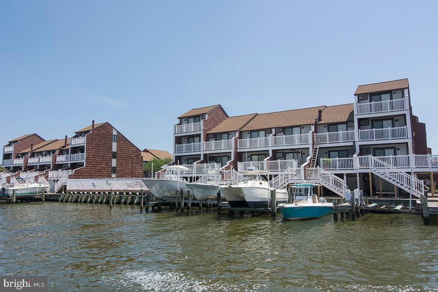 Bayside waterfront 3 bedroom 2 1/2 bath END UNIT townhome with deeded boat slip and outdoor pool.  Recent upgrades includes Stainless appliances, granite coutertops, cabinets, recessed lighting, new bathroom  sinks and fixtures, new flooring, new window treatments and blinds. FIVE  private decks, three on the waterfront have just been replaced by the association, two on the front side to be replaced this year.  Other recent improvements: Pool upgrade, parking lot New roof. Turnkey and ready. Excellent shape! Great second home or rental investment. Located close to outdoor pool