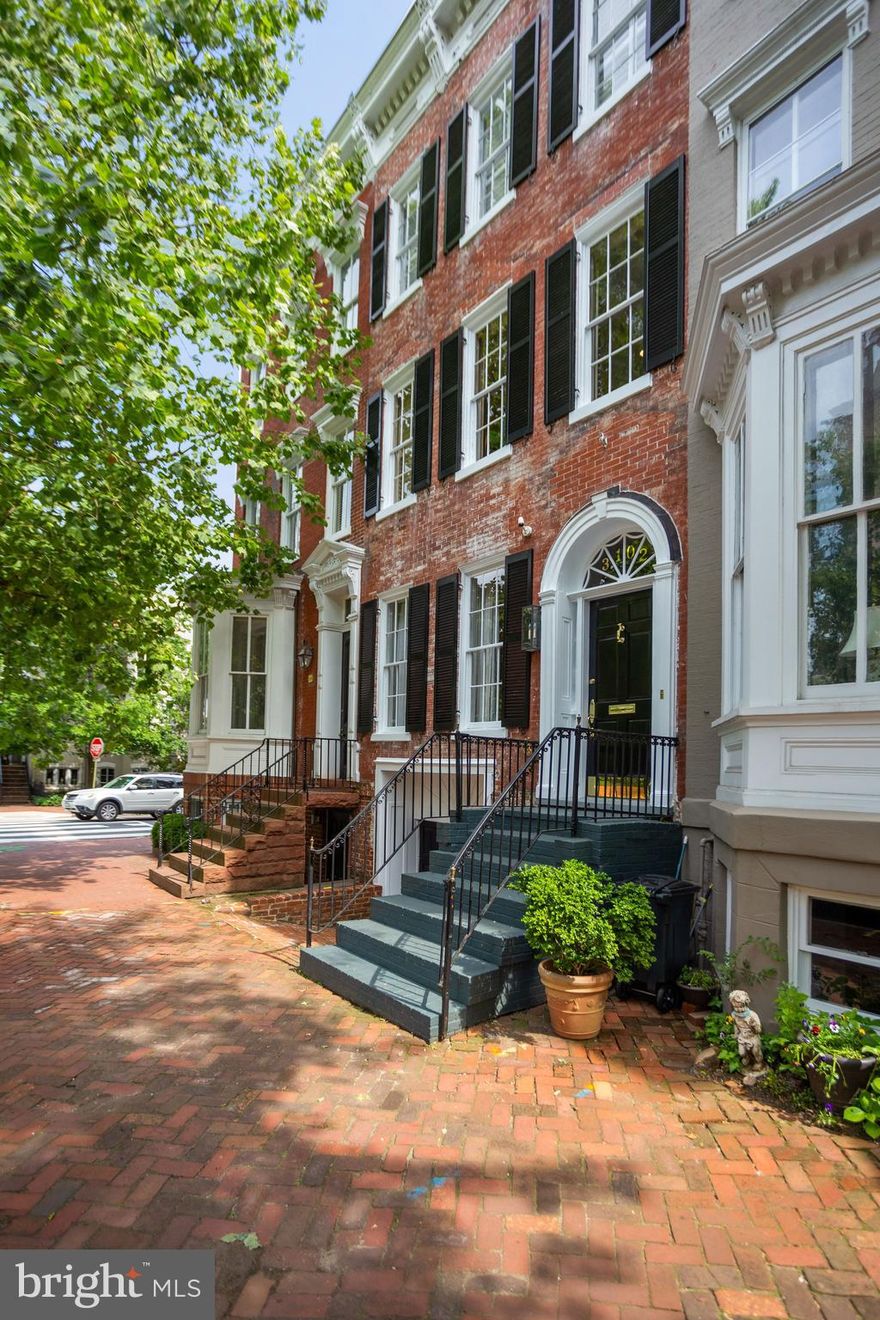 This tastefully renovated and flawlessly redesigned townhouse is located in the heart of Georgetown's East Village, just blocks away from shops, restaurants and entertainment. Features throughout include high ceilings, hardwood floors, original details, and generous rooms with large windows flooding every space with natural light. Beautifully renovated by Chryssa Wolfe in 2016 with high-end finishes throughout, this home showcases a generous Entry Hall, double Living Room with matching wood-burning fireplaces, Dining Room with built-in banquette seating and Wet Bar, and Chef's Kitchen with marble countertops and SubZero and Wolfe appliances; both Dining and Kitchen feature their own set of French doors to gorgeous rear Garden with fireplace. Upper Level features gracious Owner Suite with 3 deep double closets and Waterworks en-suite Full Bath with Carrera marble counters, Bedroom / Upstairs Den with wood-burning fireplace.  Leading to Third Level is a large, south-facing Sun Deck with views of Georgetown gardens. Bedroom #1 and #2 feature decorative fireplaces and share an updated white Kohler Full Bath. Lower Level features additional Family Room with vinyl wood flooring, Full Bath with shower and marble countertops, Kitchenette with stainless steel appliances, Laundry Area, and access to full-size 1-car Garage.