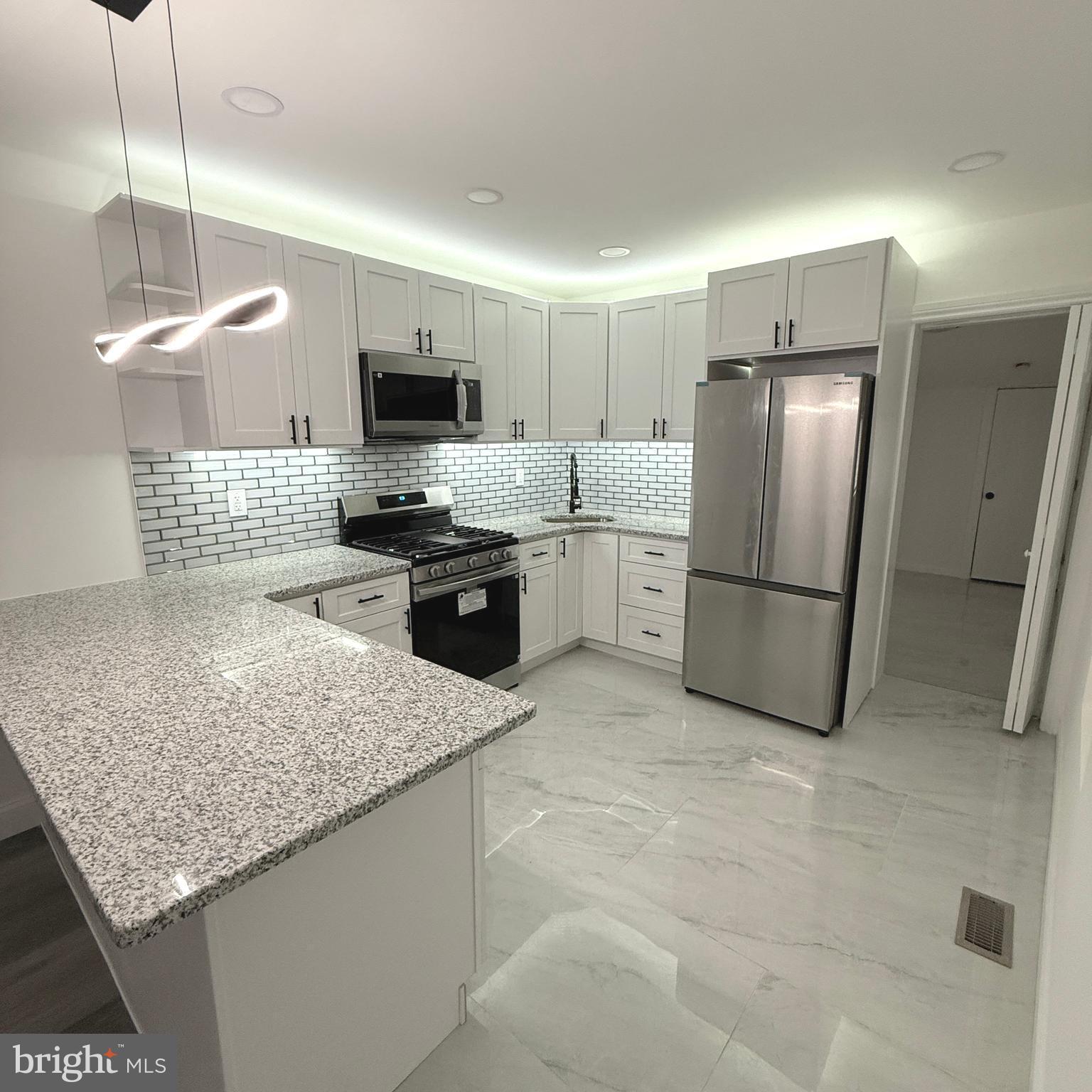 Welcome to this beautifully renovated 3-bedroom home with 1.5 baths, extra room, and a finished basement! This house has luxury vinyl planks throughout, recessed lighting, LED mirrors in the bathrooms, brand-new windows, window shades, and a brand-new kitchen that offers white shaker cabinets, granite countertops, and stainless-steel appliances. Let’s not forget floating stairs! The first floor has an open floor plan with a kitchen and living room, and an extra room in the back, which can be used for an office, large pantry or storage. The second floor features 3 bedrooms and a full bathroom. The basement is finished. It is the perfect place for gatherings, an exercise room, an office, or a play area. A new HVAC system, water heater, washer and dryer. The house is conveniently located near public transportation, shopping, and easy access to Center City and major highways. Schedule your appointment today! Come and see what this house has to offer!