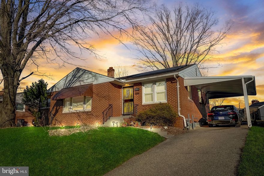 Classic Mid-Century Modern rancher nestled into the heart of the vibrant Crosier Gardens neighborhood of Suitland.  This lovely all brick home offers a spacious floor plan with solid hardwood flooring and tons of natural light throughout.  There are three great-sized bedrooms on the main level with ceiling fan overhead lighting and space-saving sliding closet doors. The primary bedroom features a private ensuite bath and large walk-in closet. The main hall bath has been updated to include new tile shower walls with inlayed storage, upgraded shower system, comfort height vanity, claw foot soaking tub, and massive walk-in storage closet with installed shelving system. There is an efficient and well-equipped kitchen with beautiful custom wood cabinetry featuring soft close drawers, built-in broom closet and garbage storage, stunning quartz counters, above range pot filler, amazing glass backsplash, custom recessed and under cabinet lighting, and a deep farm-house style sink. The appliances have been updated to include a dual -oven gas range, built-in microwave with air frying and convection features, separate wine/beverage fridge, and full-sized GE Cafe' series refrigerator with door dispenser and remote app controls. Downstairs you will find a large finished basement with open rec room area, two additional rooms, another updated full bath, laundry, and tons of additional storage.  This home features an array of additional features such as a whole house water softener, solar energy, covered off-street parking, and a temperature-controlled solarium addition with beautiful panoramic views of your privet rear yard.  This neighborhood is super convenient with 1/2 mile distance to Suitland Metro station as well as 3 grocery stores and an abundance of shopping and restaurant options. The new middle school as well as elementary and high schools are all within walking distance. A commuter's dream with quick access to downtown DC, National Harbor, National Stadium, and Northern Virginia.