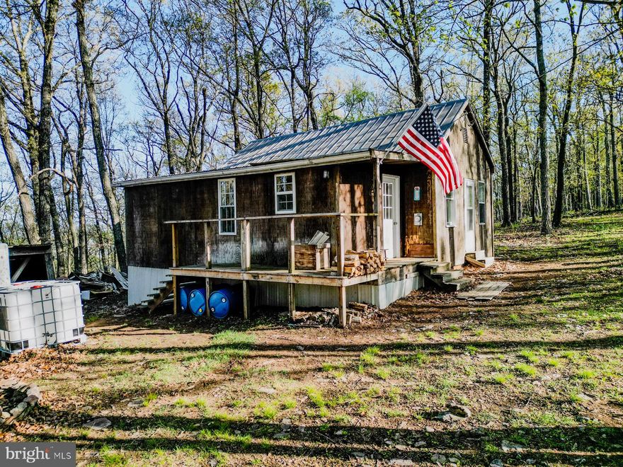 Welcome to your private mountain retreat in Hampshire County, WV, offering a total of 82.27 acres across three separate parcels. This property includes a 52-acre unrestricted tract with a fairly level ridge where a furnished 3-bedroom rustic cabin sits tucked among the trees. The cabin is currently being remodeled, and all building materials on-site will convey, giving you a head start to finish the job your way. Electric is already installed, and a small spring-fed pond adds charm and natural beauty. While there’s no well or septic in place yet, the cabin is plumbed for a kitchen sink and bathroom, and the included water containers on-site make it easy to set up a rainwater catchment system—perfect for weekend escapes or off-grid living.

The additional two adjoining lots—one 16 acres and one 14.27 acres—are part of the Sky Blue Acres subdivision, giving you flexibility to create a multi-family compound or simply expand your space and privacy. Access is a breeze with two points of entry: one through Sky Blue Acres and the other via a deeded right-of-way through the well-maintained Bristol Springs subdivision on the other side of the mountain.

This land is a hunter’s paradise, rich in mature oak and hickory forest and teeming with whitetail deer, wild turkey, and even black bear. Whether you're looking to hunt, hike, camp, or build your dream home or mountain lodge, the possibilities here are endless. You’re just 10 minutes from the Slanesville General Store for fuel, groceries, and a bite to eat, 20 minutes to Augusta, 30 to Capon Bridge, and only 45 minutes from Winchester, VA, for all your shopping needs.

If you've been dreaming of fresh air, mountain views, and wide-open freedom—this is your chance to own a true slice of West Virginia heaven. Opportunities like this don’t come along often. Claim your mountain escape before someone else does.