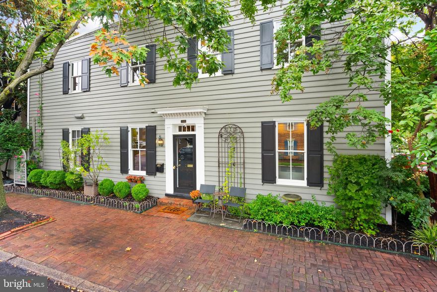 THIS is the one you have been waiting for in Old Town Alexandria! Nothing to do but move-in. You will not find a better restoration - modernized and improved for today's conveniences, but finished in absolutely perfect period detail (down to the doorknobs) so you don't lose that spectacular Old Town charm! After purchasing the home in 2019, the current owners got to work to make this fabulous two-level historic space more livable and smart. Starting with new Pella high energy efficient windows (including hurricane glass on the main level and true to historic detail with Italianate wooden frames with actual divided light panels) and completely renovating the kitchen layout so that you have an exit to the private courtyard from the main home and a functional laundry room. This renovation really opened up and enlarged the kitchen space, making it perfect for even the most discerning chef! Top of the line appliances, custom cabinets and expansive Quartz countertops make this truly a dream kitchen. The wall of windows that lead to the private courtyard bring in so much natural light!

The hardwood floors, as well as the wood work, were refinished and repaired throughout the home, bringing back to life the gorgeous flooring and trim. Lighting was updated in the kitchen, dining and hallways, but carefully selected to capture the vibe of the 1900 architecture and detail. Modern conveniences such as custom shelving from Closet America were added to make storage more functional in all of the bedrooms. Built-in bookshelves were reimagined in the formal living area - perfect to relax by the cozy wood-burning fireplace. Truly no detail was overlooked here!

Upstairs you will find 3 bedrooms, including a primary with THREE closets, an en suite bathroom and plenty of space for a king-sized bed. The hallway leads to two other bedrooms, a light-filled gallery space and finally a bonus family room that is perfect for movie night, with built in bookshelves and a cozy space that could also double as guest lodging.

The spacious courtyard area is shaded with a mature Magnolia tree and the ambience is just perfect! Hot tub and cover both convey and you can not find this sort of charming outdoor space here in Old Town. The decking is Brazilian Ipe and just warms up the space connecting the main home and the semi-attached garage (the courtyard was also waterproofed and a drain system was installed in 2019). There is also an automatic irrigation system.

Over the last four years other improvements have been made, such as converting the water heater to a tankless system and adding drywall, an epoxy floor and recessed lighting to the garage. Just this summer, outdoor shutters were replaced and the roof was patched and coated (carries a warranty transferable to the new owners). There really is nothing more to do except pack your bags!

Located in the heart of Old Town, you cannot beat the location! On a quieter residential street, but just 4 blocks to the many shops and restaurants on King Street, Trader Joe's and Harris Teeter, 7 blocks to the Braddock Road Metro Station (approx half a mile) and 8 blocks to the Waterfront. Off street parking and storage abounds in the attached garage PLUS the attic has over 200 SF of additional storage space as well. This truly is an opportunity not to be missed!