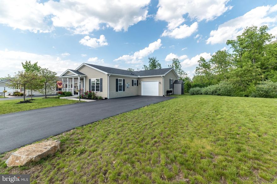 Welcome to the sought-after Spring Valley Village 55+ Community.  Built in 2019,  this beautiful home offers one-floor living with  SO many upgrades. The home features a large front porch with manicured landscaping. Entering the home, you will love the open floor plan. The kitchen is a chef's delight, with upgrades galore, including a large Island, refinished cabinets, and gorgeous mahogany countertops. The kitchen opens to the spacious dining and living room area.  You will enjoy having the energy-efficient freestanding natural gas stove in the living room. You will really appreciate this feature on those cold winter days. The spacious laundry room is right off the kitchen and leads to the oversized attached garage. The primary bedroom features a large walk-in closet and a full bathroom with a walk-in shower. There is an additional bedroom/flex room with a convenient full bathroom across the hall. If you like a private setting, this is your home. The home backs up to woods and has an amazing patio with a gazebo.  A quiet and peaceful space to relax and enjoy nature. To top this off, this home has an oversized lot.  There's also a shed for extra storage. Spring Valley Village features a large clubhouse and walking trails.  The clubhouse includes a library, game room, and fitness area. Spring Valley Village is close to shopping, restaurants, and medical offices. This home is a dream come true. Don't miss the opportunity to own this beautiful, well-loved home.