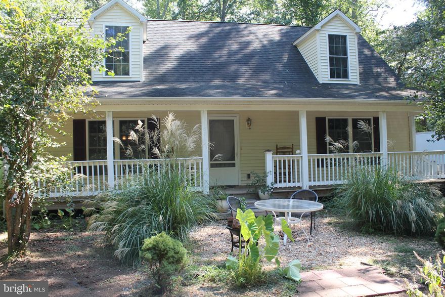 PRICE REDUCED!! Imagine waking up to the tranquility of a peaceful established community. This charming cape cod-style home offers a truly unique blend of quiet living and endless water adventure. With 3(potentially 4) bedrooms and a layout designed for comfortable living, this home is both spacious and cozy. The main level  welcomes you with beautiful hardwood floors. a bright open living room and dining room, and a kitchen outfitted with all the "extras" you could want. At the back you'll find a versatile bonus room- perfect as a sun-drenched office or a relaxing sunroom. Two bedrooms and a full bath conveniently located on this level along with a dedicated main level laundry room. 
Upstairs is a spacious retreat. It currently features one massive bedroom and an additional full bath, but with a simple dividing wall you could easily create two separate bedrooms offering flexibility. 
Step outside to your newly built maintenance free deck to enjoy the fresh air or settle on the delightful front porch with your morning coffee. The home sits on a approx 1/2 acre lot but a true game changer is a second lot 1/2 acre is included giving you unmatched privacy or potential to build a second home or workshop. Beyond the property the community truly shines! Enjoy active afternoons with access to the clubhouse. inground pool, tennis courts. and basketball courts. For the water enthusiast there's a Marine complete with boat ramp, pier and Mooring area- everything that you need for boating, fishing and enjoying the river life. Or simply relax and take in the views of the Potomac from the picnic area. This is more than a home its a lifestyle. Don't miss your chance to secure this perfect blend of privacy, comfort, and community.