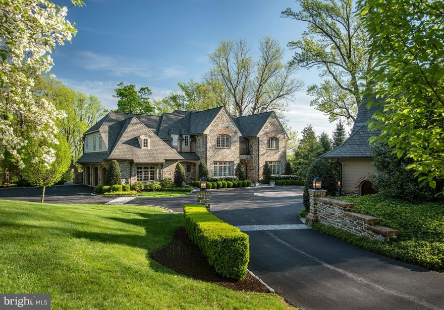 Custom built by Greenbridge Development and designed by McIntyre-Capron, this exquisite Estate Manor home offers the highest quality construction and stunning design. Enjoying a prime location adjacent to Applebrook Golf Club, the expansive 2-acre property is brimming with beautiful landscaping and hardscaping, and greets your arrival with stately entrance piers. A private driveway with Belgium block detailing proceeds to the majestic house that oozes curb appeal, with a Mica schist stone facade with brick detailing.  Attention to detail is on full display everywhere you look; from the Hardie Plank cladding, Grand Manor roof with snow guards, copper roofs, gutters and downspouts to the large stone steps reclaimed from the neighboring Clock Tower Manor Farm. In addition to abundant parking there is an attached 3-car garage.  This detached 3-car garage Carriage House was built with the same architectural style and quality as the residence and offers second floor space that could be finished with endless possibilities; as it has been fitted with public sewer, water and utility system. Inside, architectural details abound, and brilliant natural sunlight brightens each room. A wainscoted foyer, airy 10’ ceilings, 4” white oak flooring, and stunning barreled casement archways grace the main level and are representative of the rich, solidity of the home.  For the host awaits a spacious living room with arched opening to a fireplace nook and an elegant formal dining room for entertaining. Culinary creations and family together time are inspired in the generous gourmet kitchen appointed with top-quality appliances, marble countertops, thick marble center island, and soft-close cabinetry fabricated by Amish craftsmen. Also nearby is a walk-in pantry for the ultimate kitchen organization, and an adjacent breakfast room with vaulted ceiling and curved wall of windows. The family room is perfectly positioned next to the kitchen and features an elegant, coffered ceiling and limestone fireplace. A dazzling bonus room has a full bar and a Nano-Wall door system that open completely onto the covered, vaulted rear terrace with fireplace, and reveals breathtaking views of the rear grounds. The ultimate Indoor/Outdoor living experience at its best! The main level is further enhanced by a study; as both rooms are appointed in mahoghony paneling and detail. Two powder rooms, plus a mudroom with cubbies and garage access. The rear grounds include an uncovered flagstone terrace and expansive lawn, affording unparalleled outdoor pleasure. The second floor is highlighted by five well-proportioned bedrooms (3 en-suite) and includes the primary bedroom retreat with a sitting room, walk-in closet with a center island of drawers, and luxurious spa bath. The hallway has oak flooring, a curved wall, and opens to a computer / homework area. A laundry room includes two sets of washers/dryers, folding surfaces and utility sink. Two secondary bedrooms share a full bath. A staircase ascends to the unfinished third floor which is great for storage or can be converted to finished living space. The newly carpeted, day-lit lower level has something for everyone with a recreation area, home theater, large fitness area, yoga/meditation room, and soothing full bath with sauna. A whole-house AV system, custom window treatments, state-of-the-art mechanicals and more elevate the lifestyle.