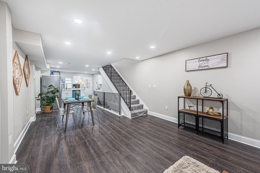 PICTURE PERFECT DESIGNER RENOVATION WITH OVER 1,500 SQ. FT. OF LIVING SPACE!  Features include an open floor plan with wood flooring throughout the main level, a spacious living room and dining area, gourmet designer kitchen with unique accent wall, Quartz counters, & ss appliances, upper level Primary bedroom suite with a full bath, 2nd bedroom with a hall bath, a fully finished basement with a family room, 3rd bedroom, and 3rd full bath, a large rear deck and an inviting front porch!  Convenient to Johns Hopkins University, tons of restaurants, and major roadways.  Pack your bags and move right in!