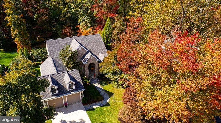 This spectacular custom home is truly Architectural Digest worthy, providing a perfect blend of sophistication, comfort, and architectural artistry.   Once the personal residence of a renowned Vienna architect, it was crafted with exceptional quality and thoughtful design throughout. From the graceful stone-arched entry to the vaulted wood ceilings and walls of windows, every element reflects craftsmanship rarely found today.

Offering over 5,000 square feet of inspired living space, this 4-bedroom, 4.5-bath home is beautifully sited on a .37-acre landscaped lot backing to trees, creating a peaceful, private oasis alive with birds, wildlife, and seasonal color. The design provides main-level living at its best, featuring a luxurious primary suite with spa-inspired bath and three additional spacious bedrooms—two with ensuite baths—and options for a fifth bedroom.

The gourmet kitchen will delight the most discerning cook, with stainless appliances, quartz countertops, 42-inch wood cabinetry, walk-in pantry, and an adjacent four-season sunroom that opens to the deck and patio for effortless indoor-outdoor entertaining. The family and dining rooms showcase vaulted wood ceilings, skylights, and panoramic windows, filling the home with natural light, warmth and pretty views.

A main-level office with private exterior entrance offers flexibility for remote work, while the upper-level loft provides additional space for a second office, gym, or teen retreat.  The walk-out lower level features a spacious recreation room, guest suite with adjacent renovated bath, sitting area, and abundant storage. Professionally landscaped grounds complete this tranquil retreat, offering rare privacy just steps from Vienna’s vibrant downtown.

Located within the sought-after Madison High School pyramid and near top private schools including Flint Hill, this home offers exceptional educational options. Enjoy an easy walk to the Vienna/Fairfax Metro, and minutes to Church Street shops, restaurants, and the W&OD Trail. Embrace Vienna’s lively small-town charm at events like ViVa Vienna, Chillin’ on Church, Oktoberfest, the Halloween Parade, and Taste of Vienna, or enjoy performances nearby at Wolf Trap National Park for the Performing Arts. With quick access to Tysons, D.C., and the Pentagon, commuting is effortless via Routes 66, 495, 123, and 50.

Recent updates include a 30-year architectural roof and HVAC (2024), powder room addition (2023), kitchen appliances (2020), washer/dryer (2019), and water heater (2016). Freshly painted and truly move-in ready, this one-of-a-kind Vienna residence is a 10+++!