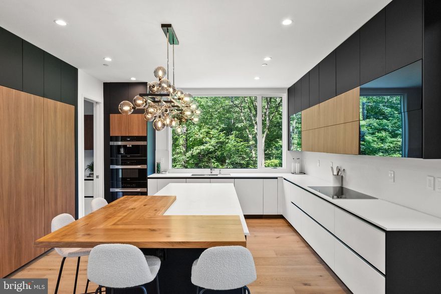 Some of the finest homes in Washington D.C. could soon be yours with this brand-new development named The Mulberry. With three gorgeous modern residences designed by renowned architect Richard Williams of RWA, and constructed by the esteemed team of CoreBuild+.
Style meets substance in this 6-bedroom, 5.5 -bathroom home with elevator to all levels, and high ceilings spanning 6,100 SF. The Entry Foyer with a built-in mudroom leads to the Grand Recreation/Living Room with direct access to the rear garden. A Bedroom/Gym, full bath, with laundry room, and access to the 2-car garage complete this level. Climbing the open-riser stairs to the Main Level, Slider Doors open to the expansive deck and side garden. Enjoy cooking in the state-of-the-art Bauformat Kitchen, fitted with top-of-the-line Miele appliances. Entertain in the spacious dining and sitting areas and rest easy in your Living Area complete with a cozy suspended fireplace, high-end sound and more. The Living Area leads to a Bedroom/Office Suite completing this level. The Second Level includes the lux Primary Suite with incredible Forest Views, Walk-in-Closet, Balcony, Primary Bath with tub, shower, and double vanities displaying Brizzo and Grohe water fixtures throughout the home, as well as three additional Bedrooms, two Baths, and a Laundry Room.
Every detail of this residence has been meticulously thought out to bring you the highest quality from the ground up. You'll find only the best materials, from dry laid paving at the entrance to quality decking in the outdoor spaces. High-end finishes flow throughout including glorious 9’ hardwood flooring, a designer Visual Comfort lighting package for an incomparable blend of beauty and life-enhancing smarts.
Outside, greenery truly surrounds you, with the home located in a unique location overlooking the federal parkland. Here you'll find yet another example of architectural forward thinking, with the front elevation of your home with a cantilevered design and large Windsor Windows to make Rock Creek Park look like your own private front yard with a stream running by.
Situated in one of the most sought-after areas in all of Washington D.C., you'll have the best restaurants and shops right on your doorstep and be only a stone's throw away from central downtown and the airport. Take advantage of easy access to some of the most beautiful natural areas around, including Rock Creek Park and Smithsonian National Zoological Park, and get your culture fix at Kennedy Center, Hillwood Estate or Pierce Mill.  Zoned for Murch ES, Deal MS, and Jackson-Reed HS.