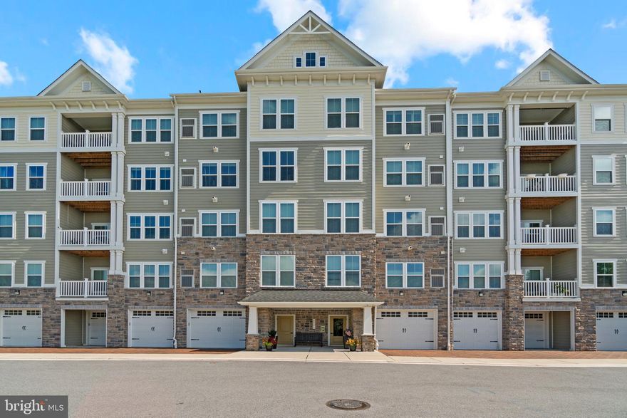 GORGEOUS 4th-level condo in the ESTEEMED Ellicott's Retreat 55+ community. This condo has been lovingly cared for and tended to. From the moment you walk in, you will feel the sophistication, elegance and secluded nature of this very special condo!  Overlooking a blanket of green trees below, you can look out above the treetops and see for miles! Inside, this beautiful home gets plenty of afternoon natural light, with an entire wall spanning the length of the condo that overlooks trees providing an extensive skyline view and sunset! A sleek and functional Kitchen is any chef's delight with SS appliances, granite countertops, 42" cabinets, and dreamy-colored subway tile backsplash across both walls. The kitchen sink and some counter space faces out to the LR and has amazing views of the tree tops and skyline, also looking out to the living and dining areas. A private balcony off the living and dining area shares the same peaceful and priceless view! Upgraded lighting fixtures in the kitchen and dining areas are both rustic and contemporary.  In the primary bedroom, the builder floors have been replaced with wood flooring! Lots of sunlight streams through these windows, which also provide the coveted treetop and skyline view! Dual sinks in the primary bath and 2 large closets complete this primary ensuite! The secondary bedroom is attached to a full bathroom with a tub/shower, and this bathroom also connects to a hallway toward the condo entry. Secondary bedroom has plush low-pile carpet, an attractive neutral light color and pretty and seldom found pattern! The secondary bedroom also boasts a BONUS room, which is currently used as a home gym, but could function as extra closet/storage space as well.  There are closets everywhere in this condo, so bring everything you own!  Washer and dryer in unit is just outside of the secondary bedroom.  But wait! There's MORE. An extra-deep 1 car garage comes with this condo, plenty large for any modern size vehicle - and then some storage space too! Lots of parking is available in the lot, which provides unassigned spots. Ellicott's Retreat has an active social committee that hosts regular cookouts/bbq's and other special events. The Community Center building provides space for conference meetings, recreation and relaxation. HOA fees INCLUDE WATER (no separate bill or water fee)!!  Ellicott's Retreat is conveniently located in walking distance of shopping and the Howard County bus line that goes to the Miller Branch Library and the Senior Center. Major travel routes are a hop, skip and a jump away, as well. PROFESSIONAL PHOTOS COMING APPROX 9/13.  Showings will be available by appointment only, from 10:00 a.m. through 7:00 p.m. PLAN YOUR SHOWING NOW!