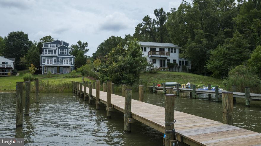 Enjoy stunning waterfront views in this brand new home! An entertainer's escape with an open floor plan, and ample indoor and outdoor space on every level. With a coffered ceiling in the living room, red oak floors and two full kitchens, this home's details are sure to impress. This tech-savvy home has built-in speakers throughout, a security system with wiring for cameras, and much more!