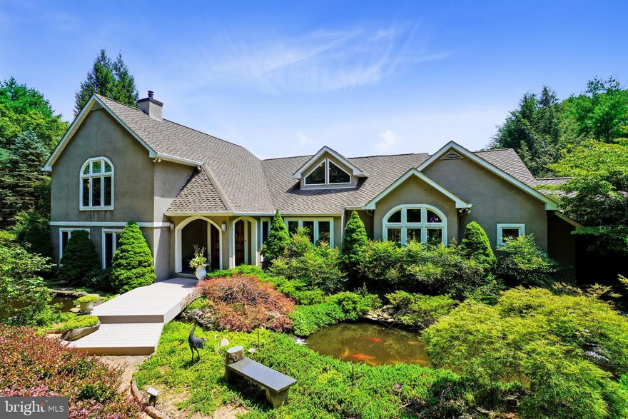 Experience this impeccably maintained, architecturally interesting contemporary tucked away on 2.1 private acres with over 7,000 finished sq ft with soaring ceilings, quality finishes throughout, an abundance of windows with beautiful views & an open flr plan for today's living---A generous first flr includes a front hall w/custom wood doors, library w/built-ins, living rm w/granite flrs & cathedral ceiling, dining rm w/vaulted ceiling & built-in buffet + a wall of glass cabinets, family rm w/FP + a wet bar surrounded by windows, a "Cooks" eat-in kitchen w/granite ctops & island + KraftMaid cherry cabinets & a laundry/mudroom---The master Brm wing encompasses the entire 2nd level including a sitting rm, two walk-in closets, a spacious Brm w/a raised gas FP & vaulted ceiling + a master bath w/ limestone flrs, steam shower & jetted Cielo tub---The fully finished lower lvl includes a family rm w/FP, sunroom, bedroom & bath, exercise rm, wet bar, a 25 x 19 Home office & more---Relax and enjoy the views from the multiple stone patios & the Azek L-shaped deck---An Azek front walkway/bridge w/2 Koi ponds guide you to the front entrance---EZ access to I-83 & minutes from Hayfields golf course, the Oregon Grille, NCR Trails, Hunt Valley Towne Center, Wegmans & more!