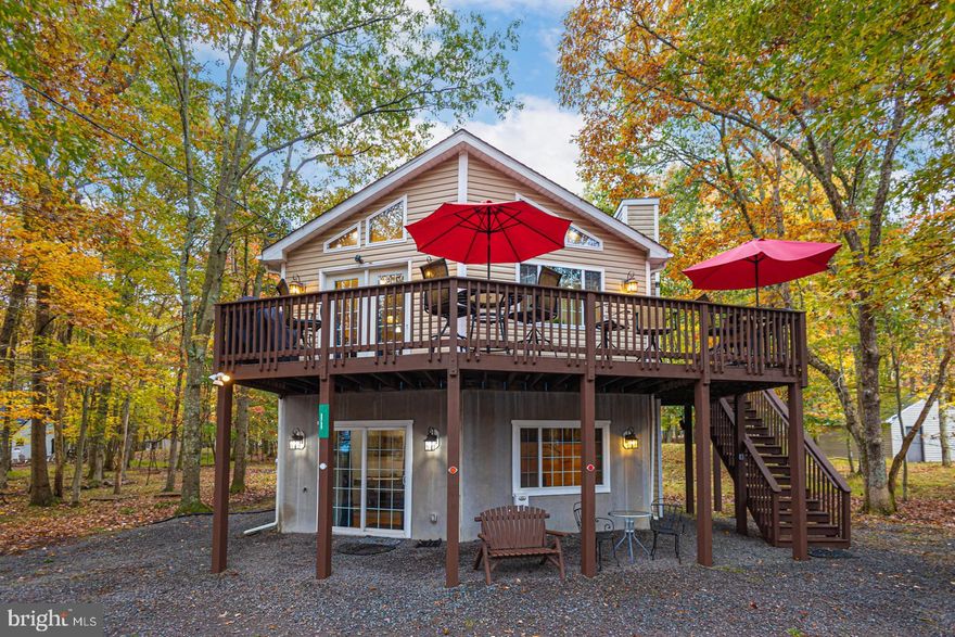 Don't miss this fantastic well maintained 4 bedroom, 2.5 bath raised ranch in amenity filled Towamensing Trails! This home features an open concept kitchen, dining room and living room with a wall of windows that drench the main space with lots of natural light. Downstairs you will find a large family room, game room, bunk room, half bath and a Kitchenette! Enjoy nature from the wrap around deck or the patio and hot tub around back! Plenty of room for the whole family, CENTRAL AIR CONDITIONING and two fireplaces will keep you comfortable all year long! Home is being sold furnished.  Turn key ready to rent with  a great rental history!