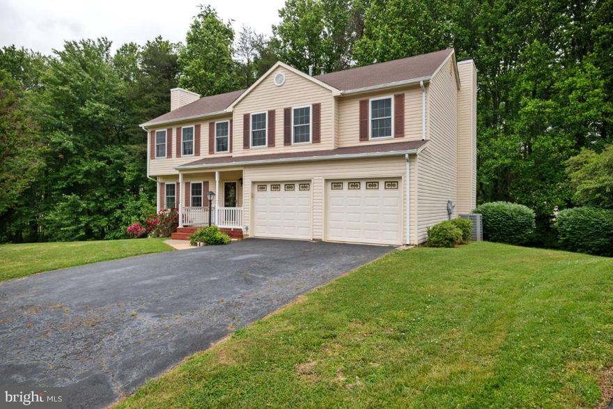 Large colonial at the end of the cul-de-sac backing to woods! No HOA! 4 bedrooms and 2.5 baths await you in this home! Large family room addition off the kitchen with wood burning  fireplace.  Spacious master suite with fireplace and two walk in closets.  The skylight allows natural lighting in the master bathroom with soaking tub and separate shower.  Two car attached garage with extra storage.  Enjoy your evenings on the deck or the concrete patio below. Unfinished walk out basement to expand to your liking!