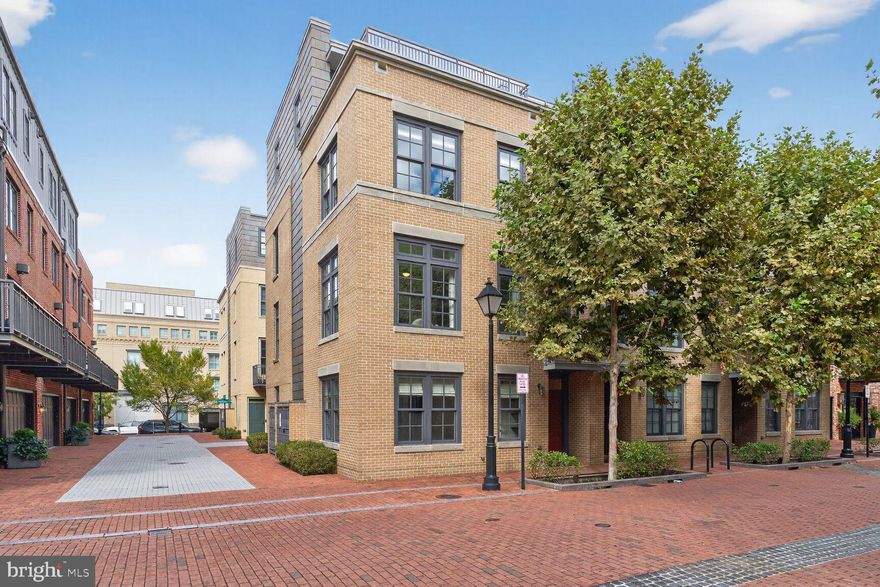 ** OPEN HOUSE SUNDAY 10/26 FROM 2-4PM ** Stunning End-Unit Elevator Townhome in Robinson Landing ** 
Experience unparalleled Old Town Alexandria living in the largest model townhome at the sought-after waterfront community of Robinson Landing. This rare end-unit residence blends luxurious design with an open, light-filled floor plan and hardwood floors throughout. **

Elegant Main Level: 
The gourmet kitchen impresses with quartz countertops, ceramic tile backsplash, sleek Snaidero cabinetry, stainless-steel appliances (including a gas cooktop with range hood, wall oven, built-in microwave, refrigerator, and beverage fridge), plus a large island with pendant lighting and seating. A built-in desk, coffee bar, and walkout to a deck with natural-gas hookup create the perfect everyday and entertaining space. The adjoining dining area—complete with a custom chandelier and glass table that conveys—flows seamlessly into the living room featuring a cozy gas fireplace with granite surround, custom window treatments, recessed lighting, and a wall-mounted TV. A stylish powder room with quartz counters and a lighted mirror completes this level. **

Private Upper Levels: 
The primary suite offers two walk-in closets and a spa-like bath with dual-sink vanity, lighted mirrors, and a walk-in shower. A second bedroom includes a private bath and walk-in closet, while a convenient laundry room provides quartz counters, cabinetry, and a front-load washer and dryer. The top-floor loft is ideal for a family room or home office, featuring a wet bar with beverage refrigerator, marble tile backsplash, and direct access to a jaw-dropping 23' x 14' rooftop terrace with sweeping Potomac River views. An additional bedroom with en-suite bath and walk-in closet completes this level. **

Versatile Lower Level: 
A welcoming foyer with mudroom built-ins opens to a bedroom/den with full bath—perfect for guests or a home office—plus a two-car garage with automatic opener, overhead storage, and separate access door. **

Exceptional Extras: 
A private elevator provides access to all levels. Central Vacuum, Tesla Level 2 charger, ceiling mounted speakers on 2nd and 4th floors.  The property is outside the floodplain (documentation available). Robinson Landing residents enjoy an owners’ lounge, library, meeting room, gym, and yoga studio—all with water views—along with a concierge desk, pet spa, and bike workshop. **

Prime Old Town Location: 
Steps to the Potomac River, waterfront parks and trails, and only blocks to King Street and acclaimed restaurants on Union Street and the riverfront. **

Don’t miss this extraordinary opportunity to own a premier luxury townhome in Alexandria’s award-winning waterfront community.
