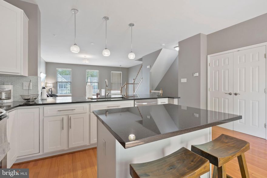 `Welcome Home to the perfect 3-bedroom, 2.5-bathroom townhome in the highly sought-after community of Piney Orchard.   Pulling into your driveway & into your garage, you will first notice the extra-large and conveniently built-in storage area above.  Walk into your home and take off your shoes within the tiled foyer area.  Don’t worry, no need to rush upstairs, as this lower level, features a half-bathroom, laundry closet and recreation room.  Endless ideas for this great space.  An office area away from the upper level? Man cave? Ladies lair? A play area for little ones? Or set up the stationary bike, yoga mat and weights to enjoy all of your workouts.  The benefits don’t end.  Take a break and open the sliding glass door to enjoy the fresh air and privacy of your own FENCED in yard that backs to the woods.  The half paved and half grassed area is perfect for pets or little ones to enjoy safe and secure. Or, maybe even enjoy some gardening and adding some color, by planting your own perennials.  Heading upstairs to the second level, the open two-story foyer and hardwood stairs lead you to a spacious open floor plan with gleaming hardwood floors throughout the entire level.  You will immediately notice the extensions/bump outs this home was originally built with, that make the living space on this level feel massive.  The dining room, gourmet kitchen and living room all have their own defined areas, but also share the benefit of the open concept. The extensive granite countertops and island area are the perfect match for the contemporary tiled backsplash and modern, upgraded 42” cabinets.  Along with all of the great cabinet space, this home also includes a good-sized double door panty. Modern stainless appliances?  Yes, of course, a French-door refrigerator with icemaker, a double-door GAS oven range, microwave and dishwasher are perfect, for a day of prepping and entertaining for your family and friends.   Once the day is over, relax and lounge and enjoy the sunset peacefully on your oversized deck.  Now that you are ready to retire for the evening, head upstairs to the top floor.  Which features 2 full bathrooms and 3 bedrooms, each with vaulted ceilings.   Upon entering the hallway, you will find the unique and conveniently placed countertops and cabinet area for storing extra linens.   Your owner’s suite features two walk-in closets, a ceiling fan and a private full bathroom with dual vanity and large soaking tub with a separate shower. The community of Piney Orchard offers amenities that include access to three swimming pools, community center, clubhouse, tot lots and pet stations, just to name a few.  In addition, enjoy the Piney Orchard Ice Rink and also, the Piney Orchard Nature Preserve for a great hiking/walking trail.   Conveniently located near the Market Place at Piney Orchard and the Waugh Chapel Shopping Center for all of your shopping needs.  Includes a 1-year home warranty through American Home Shield. Centrally located just off of route 3 with easy access to Baltimore and Washington, DC.