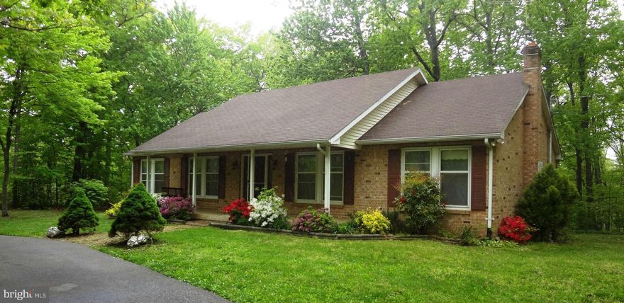 Back on the market after significant upgrades! New plumbing, new master bath shower & tile flooring, freshly painted, new carpet and more! See virtual tour for details. Spacious brick home on corner lot, excellently located on Gate 1. Full unfinished basement waiting for you to expand your living space. Level lot, nicely landscaped. Huge rear deck & sweet front porch complete with a swing!