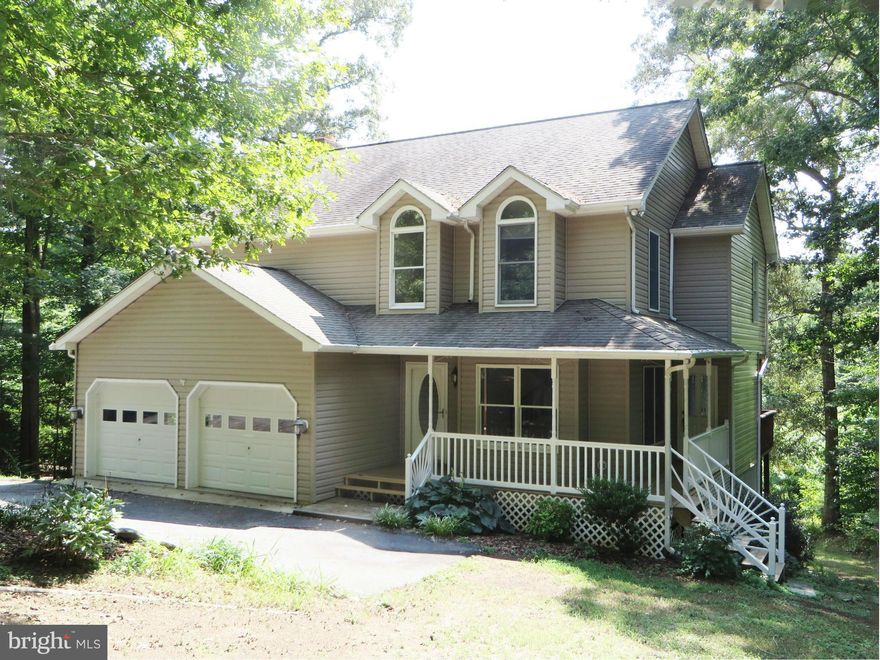 Delightful contemporary colonial w/welcoming wrap porch, on a pretty, wooded 2.5 acre lot! KT w/granite countertops, new appliances, breakfast nook; FR's wood-burning FP has tile surround; hardwood floors thruout 1st flr. Mbath w/dbl vanities, ceramic tile, jet tub, sep shower; 3 of 4 BRs have WICs. Finished walkout basement w/big rec rm, 3rd bath, storage rm. 2 decks, 2-car gar, dual-zone HVAC.