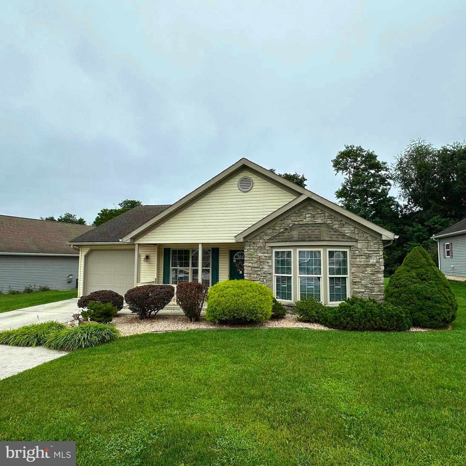 Located in the desirable 55+ gated community of Country Manor, this well-kept 2 bedroom 2 full bath home offers a comfortable and convenient lifestyle. Inside, you’ll find an inviting open-concept layout with a gas fireplace in the living room, a spacious eat-in kitchen, and a cozy den with French doors leading to a three-season porch with removable windows. Your primary bedroom holds a full attached bath & walk in closet, your additional full bath and bedroom are located off the hall. Landscaping surrounds the property, adding to its charm and curb appeal. Ideally situated near restaurants, shopping, and more, this is a home you won’t want to miss! The community features a clubhouse, stocked fishing pond, fitness center, and scenic walking trails. At least one resident must be 55 or older with no one under 21 permitted. Up to two pets are allowed. The monthly land lease is $533, which covers sewer and trash services. Sale will be contingent on community approval for the new buyer(s)