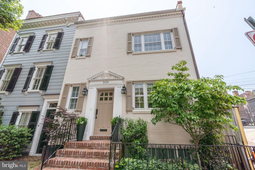 Stunning transformation of this 3 Bedroom, 2.5 Bathroom row home with private gated PARKING located in the heart of East Village Georgetown. This top-to-bottom renovation was completed in December 2022 using only the finest fixtures and finishes. Flooded with natural light and featuring incredible entertaining space, this residence blends clean modern lines with classic architectural elements resulting in stylish spaces layered with luxe décor. Entry hall with Powder Room leads into an open floor plan designed to accommodate a modern lifestyle. The gracious coffered ceiling Living Room / Dining Rooms lead to a masterfully crafted gourmet Kitchen with custom Leicht German cabinetry and a 6-seat custom Calcutta gold Quartz island.  Top of the line appliances including Miele induction cooktop (boils water in less than a minute), combi/steam oven (fully plumbed and self-cleaning), speed oven/microwave, Miele MasterChef refrigerator and a Bosch dishwasher. The main level is finished with a gas fireplace and large screen mirror/tv. Upper level features an oversized Owners Suite with 4 closets, Southern exposure and an en-suite spa Bathroom boasting floating custom cabinetry, floor-to-ceiling Porcelanosa slabs and soaker tub/shower combo. Two additional Bedrooms plus a second Full Bath featuring a walk-in Porcelanosa rainfall shower and conveniently full-size washer/dryer complete the top floor. Lower level offers a bonus Recreation Room with extra storage perfect for home office or additional guest space. All of this plus secure parking in the garden with outdoor 240 volt EV car charger.