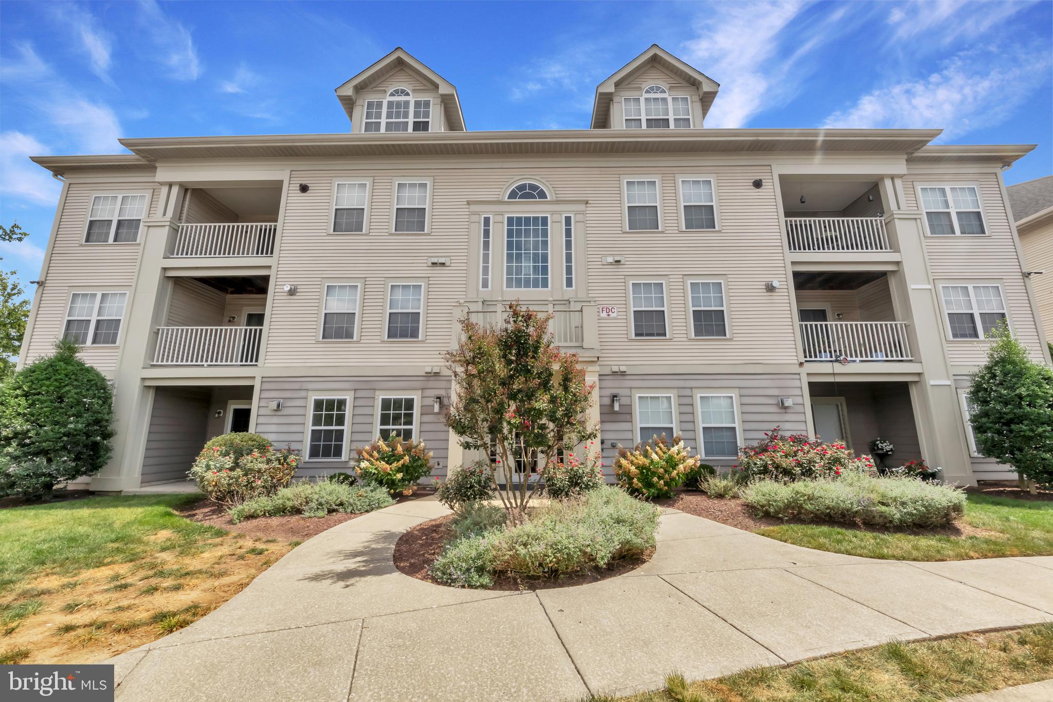 This condo in Gateway Commerce Center offers a welcoming blend of comfort and practicality, with every space designed to feel easy and livable. The wide stairwell entrance leads you into a bright upper-level home where natural light fills the rooms. The living area opens seamlessly to a dining nook and kitchen, making everyday moments feel relaxed and connected. A cozy fireplace anchors the space, while the private balcony offers a quiet spot to enjoy a breeze or catch the afternoon light. The kitchen features warm wood cabinetry, granite countertops, and stainless steel appliances—ready for both quick meals and casual hosting. The spacious bedroom provides plenty of room to recharge, with an en suite feel and great natural light.
Set in the Village of Owen Brown, this condo is part of a thoughtfully developed Columbia neighborhood known for its balance of nature and convenience. Just a short distance from Lake Elkhorn’s scenic trails and waterfront paths, you’ll have easy access to outdoor space year-round. The Columbia Mall and local favorites like Bon Fresco and The Iron Bridge Wine Company are just minutes away. The area is filled with parks, bike trails, community centers, and dining options—all connected by a strong sense of place and ease of access to commuter routes like Route 29.
If you’re searching for a home that feels both connected and calm, this one is ready to welcome you. Come take a look and imagine how this bright, functional space could work for your lifestyle. Schedule a private tour and explore what makes Gateway Condominiums such a well-loved part of Columbia.
