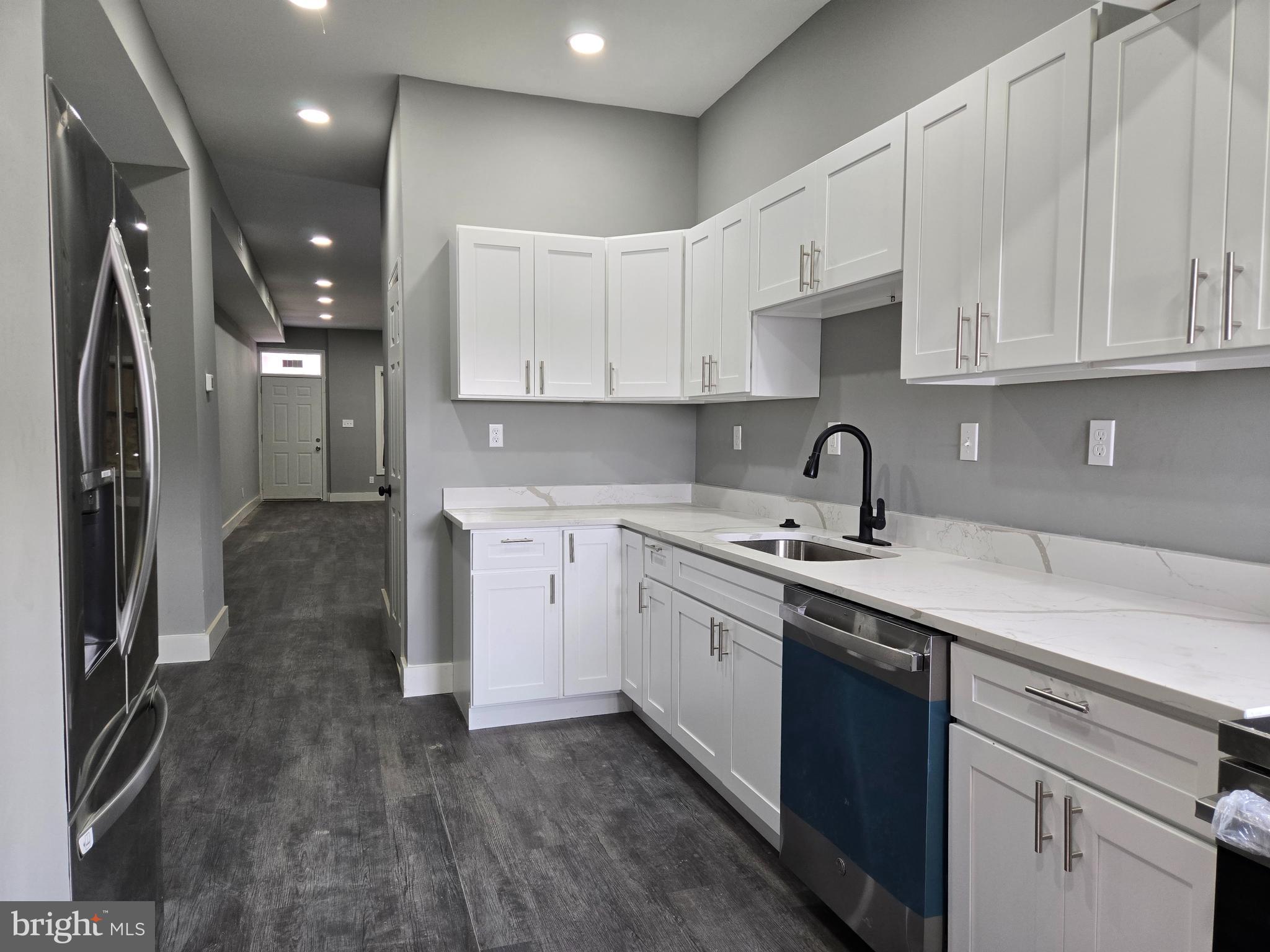 Beautifully renovated Baltimore City row home featuring 3 spacious bedrooms and 2 full bathrooms! The main level boasts a bright, open layout with a stunning updated kitchen complete with stainless steel appliances, quartz countertops, and ample cabinet space. A convenient full bathroom is located on the main level. Upstairs, you’ll find three comfortable bedrooms and a full bathroom. The fully finished basement offers additional living space and includes a washer and dryer for your convenience. This home combines modern updates with classic charm—move-in ready and waiting for you!