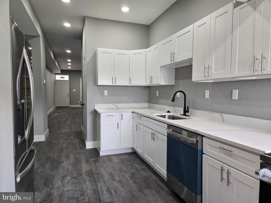 Beautifully renovated Baltimore City row home featuring 3 spacious bedrooms and 2 full bathrooms! The main level boasts a bright, open layout with a stunning updated kitchen complete with stainless steel appliances, quartz countertops, and ample cabinet space. A convenient full bathroom is located on the main level. Upstairs, you’ll find three comfortable bedrooms and a full bathroom. The fully finished basement offers additional living space and includes a washer and dryer for your convenience. This home combines modern updates with classic charm—move-in ready and waiting for you!