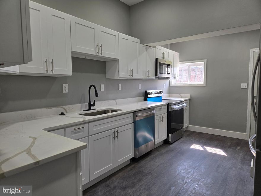 Beautifully renovated Baltimore City row home featuring 3 spacious bedrooms and 2 full bathrooms! The main level boasts a bright, open layout with a stunning updated kitchen complete with stainless steel appliances, quartz countertops, and ample cabinet space. A convenient full bathroom is located on the main level. Upstairs, you’ll find three comfortable bedrooms and a full bathroom. The fully finished basement offers additional living space and includes a washer and dryer for your convenience. This home combines modern updates with classic charm—move-in ready and waiting for you!