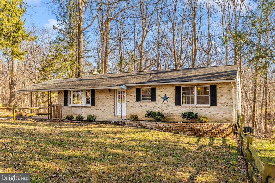 Updated rambler backing to trees located on a quiet cul de sac.  3 bedrooms and 2 full bathrooms on the first level.  The bright and sunny lower level offers a bedroom and recently added full bathroom plus a large recreational area with a fireplace and a walk out.  Interior freshly painted, hardwood floors on the first level plus newly installed flooring on first and second level.  Stainless steel appliances and granite counters in the kitchen and a bay window overlooking the front yard.  A few of the recent updates: New well pump in 2025, New washer and dryer in 2025, New hot water heater in 2025, Trane Heating and A/C installed in 2021, New sliding doors on both levels in 2023.  BAT Septic system installed in 2014.   This house is move in ready!!