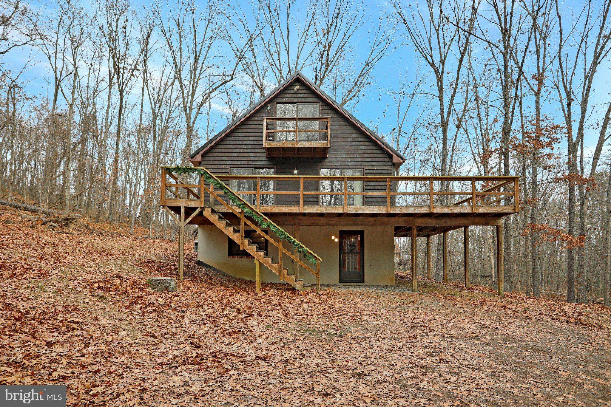 This Amazing 3 Bedroom, 1.5 bath , cabin will not disappoint if you are looking for the perfect get-a-way, Airbnb opportunity, or that Permanent home secluded in the woods. Surrounded by nature this Stunning home boasts New Floors, New Metal Roof, New Granite Countertops, Total house Re-stained, new toilets, new storm doors, etc . The open concept floorplan , and Full unfinished basement are waiting for your personal touches to make it almost Heaven . The wrap around deck is perfect for nature watching, fall cookouts, star gazing, sipping coffee, or just enjoying the Wild, Wonderful state of WV! This beauty is nestled on a private 4.21 acres with well and septic in a Established community! Enjoy your country living but still close to I-81, Rt 9, 522, Berkeley Springs, Hedgesville, MD, PA and VA! Turn Key, Make it yours in time for Christmas!