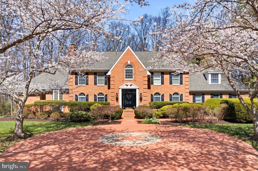 Exquisite estate living in the heart of Clarksville Set on a serene and sprawling 3-acre estate, this elegant Clarksville residence is more than a home—it’s a lifestyle. Thoughtfully designed with timeless sophistication, built for both grand entertaining and intimate living, this 5-bedroom, 4.5-bathroom masterpiece blends classic craftsmanship with modern convenience. 
This stately brick residence offers classic, symmetrical façade and beautifully maintained landscaping. The exterior features rich red brick, crisp white trim, and black shutters that frame the windows with traditional charm. A distinguished front entry with a dark paneled door and decorative pediment creates a welcoming focal point.
Step inside to discover authentic hardwood floors, and an entertainer’s dream gourmet kitchen outfitted with top-tier appliances, granite countertops, stainless steel appliances, coffered ceiling, and a brick archway opening to the family room. A sun filled breakfast/sunroom off the kitchen offers panoramic views of the pool and backyard.
The primary suite is a true retreat with an attached sitting area, spiral staircase to a private loft, and French doors leading to a private hot tub patio. The spa like bath includes dual vanities, a soaking tub, and a large glass shower. Additional living space upstairs includes a cozy loft/bonus room with hardwood floors and an arched window.
The finished basement expands the home’s living and entertainment options with multiple distinct spaces, including a dedicated home gym, a stylish media/lounge area, a full bar with seating, and a recreation room with a pool table. Industrial chic finishes, pendant lighting, and polished concrete floors create a modern, inviting atmosphere ideal for entertaining or relaxing.
Elegant design, abundant natural light, and exceptional indoor outdoor flow make this home ideal for both everyday living and entertaining.