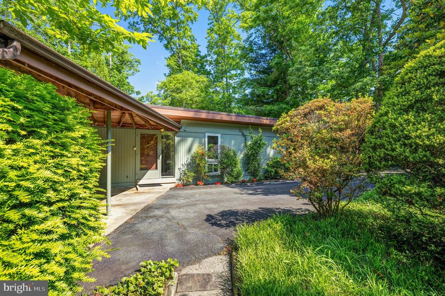 Discover the tranquility of lakeside living in this charming home on Lake Anne  -  One of Reston's original mid-century modern homes on a private, wooded inlet.  Enjoy abundant natural light and stunning views of the lake from the walls of windows.  Offering 3 bedrooms and 3 bathrooms and all the comforts of modern living.  The main level features living and dining rooms with hardwood floors and skylights.  The kitchen,  with casual dining space, includes shaker cabinets, gas stove, stainless steel appliances and granite counters.  The lower level provides a family room with fireplace and sliding glass door to patio, game room, 3rd bedroom with sliding glass door to small deck and 3rd bathroom.  Step outside to a private backyard retreat with a deck at the water's edge, perfect for kayakers and nature enthusiasts.   Take your boat from your private dock to the historic Washington Plaza, featuring dining, shops, festivals for kids and adults, the Reston Farmers Market, and more.  Take advantage of nearby amenities, including trails with easy access to the W&OD for outdoor recreation.  Conveniently located for commuting to DC, this home offers a peaceful retreat in a gorgeous neighborhood; there is a bus at the end of the street to the Wiehle metro stop.   Welcome to this special home!