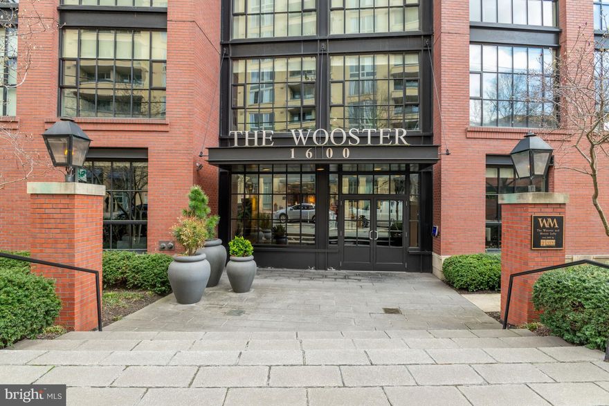 PLEASE NOTE OFFERS ARE DUE BY 2 PM  ON SATURDAY, 3/28/26. Please present your best offers, price and terms and no escalators. Thank you for showing.

If you enjoy natural light, you will love this Dramatic Loft-Style RARELY AVAILABLE CORNER UNIT..... WITH A BALCONY in the coveted Wooster & Mercer Lofts. This spacious TWO BEDROOM, 2.5 BATH WITH A LOFT/DEN IS JUST UNDER 2,000 SF (1,976 SF) with multiple walls of two story, floor to ceiling windows overlooking  several exposures spanning up the soaring 18 foot+ ceilings. This space is flooded with natural light, yet with custom shades as for needed privacy, and as a plus, the unit is located on the quiet side of the building.  Live well at The Wooster and Mercer Lofts in this unique open floor plan, including a gourmet kitchen with honed granite island and counters and high-end Sub-Zero and Wolfe SS appliances. Both full baths are finished in luxury marble and travertine stones. The upper-level loft/den adds stylish versatility to the space and the private balcony adds a touch of outdoor pleasure befitting this luxury condo. Two-car reserved parking spaces fulfill the ultimate convenience for parking in the city. It deserves repeating that this dramatic corner unit delivers true contemporary sophistication in the heart of Rosslyn and creates a dramatic New York–inspired loft aesthetic rarely found in the area. It is further complemented by a steel staircase and authentic industrial-style, architectural details like exposed brick columns, factory lighting fixtures, and visible ductwork. The open-concept floor plan seamlessly integrates living, dining, and kitchen zones, providing versatile space perfect for relaxed daily routines or sophisticated entertaining.
 Step outside to a serene courtyard featuring an in-ground swimming pool, expansive sunning terrace, meticulously landscaped lawns, and lush green space illuminated by charming gas lanterns that add a touch of timeless sophistication. The neighborhood offers endless shopping and dining options, with two nearby metro stops for effortless connectivity—and boasting a Walk Score of 97 out of 100, this location is a true Walker's Paradise where daily errands do not require a car. Modern loft lifestyle in Rosslyn is a must at Wooster and Mercer Lofts where you will experience Urban Elegance, comfort and luxury in the heart of the city. Windows sold "as is".