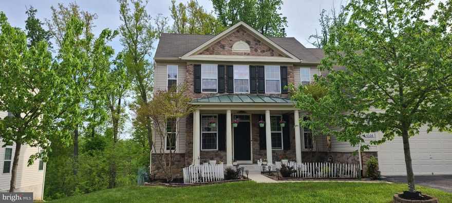 Big Estate Home of around 4,000 sq. ft. of living area.   Corner Lot. View of evergreen trees from all the three levels. Big Side Yards. Two story foyer. Exquisite designer hardwood Waterfall steps. All Hardwood, on MAIN LEVEL and also on 2ND Floor. Family Room has BRAND NEW Genuine hardwood floors. Great home for people who have allergies and want to avoid carpeted floors. Kitchen is a chef's delight : Bright, sunny kitchen gets tons of sunlight from the adjacent morning room, with a wall of windows. Kitchen has stainless steel appliances, Double Oven. Granite Countertops, upgraded cherry cabinets, Gas Cooktop. Nostalgic Front Porch, with metal roof. Fully Finished Walkout basement with additional Refrigerator. Rec Room. Upgraded berber carpet in Basement. Energy Efficient Gas hot water heater & Gas Furnace. 2 car garage, with 2 additional car parking in driveway. Original owner. Home shows pride of ownership. Very well maintained home. Excellent schools.